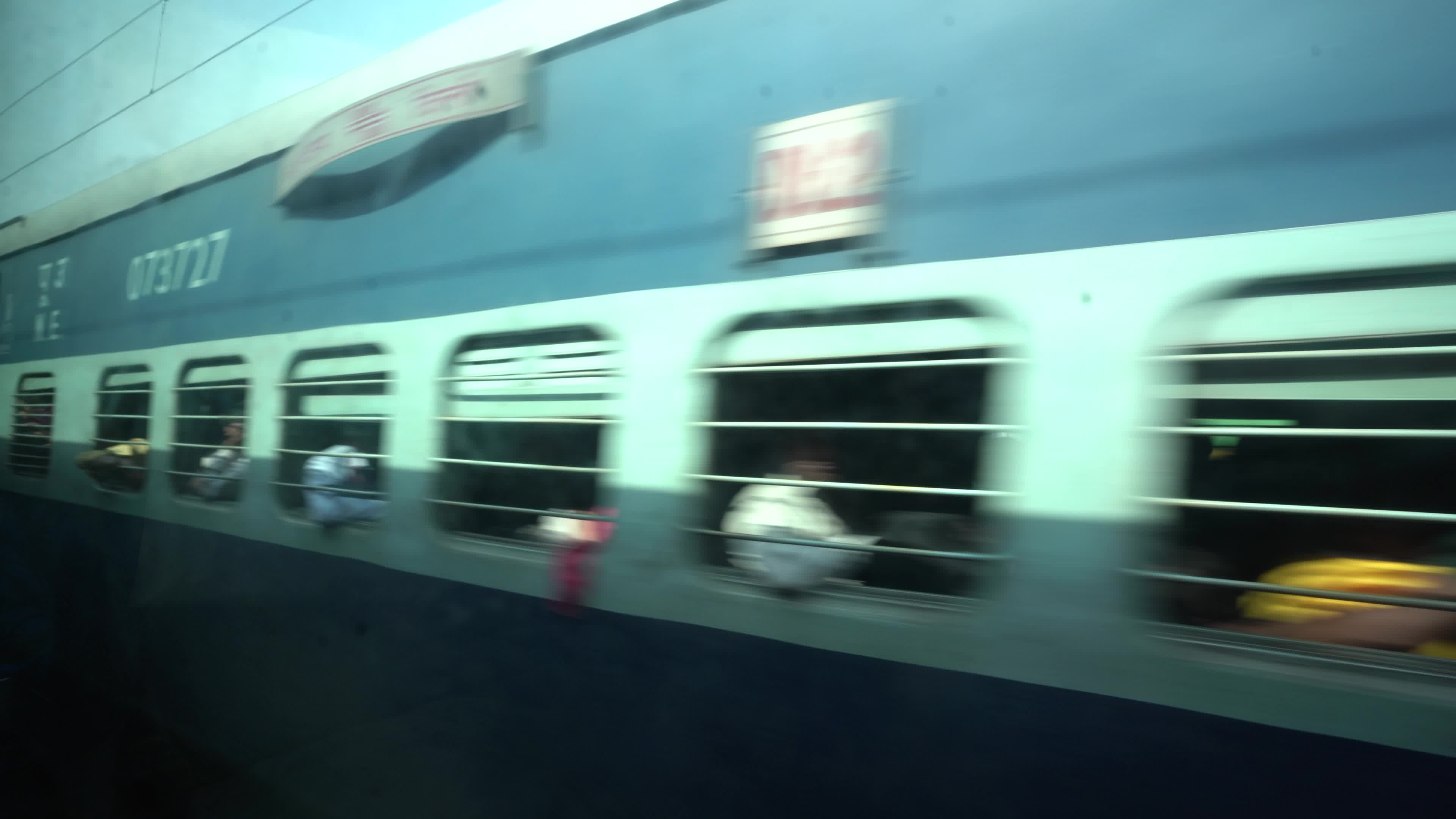 Views outside the window of a moving passenger train of Indian Railways in India