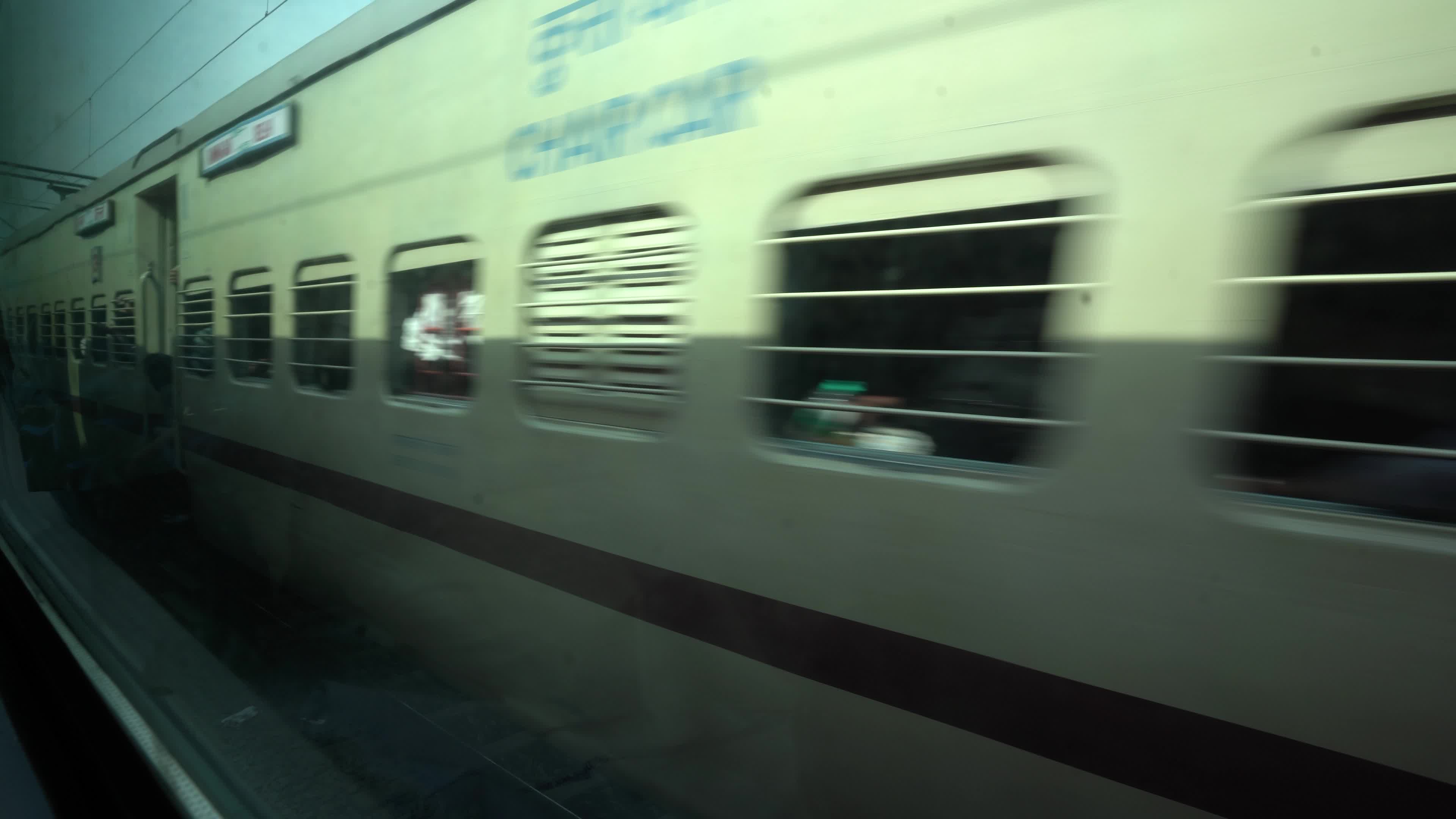 Views outside the window of a moving passenger train of Indian Railways in India