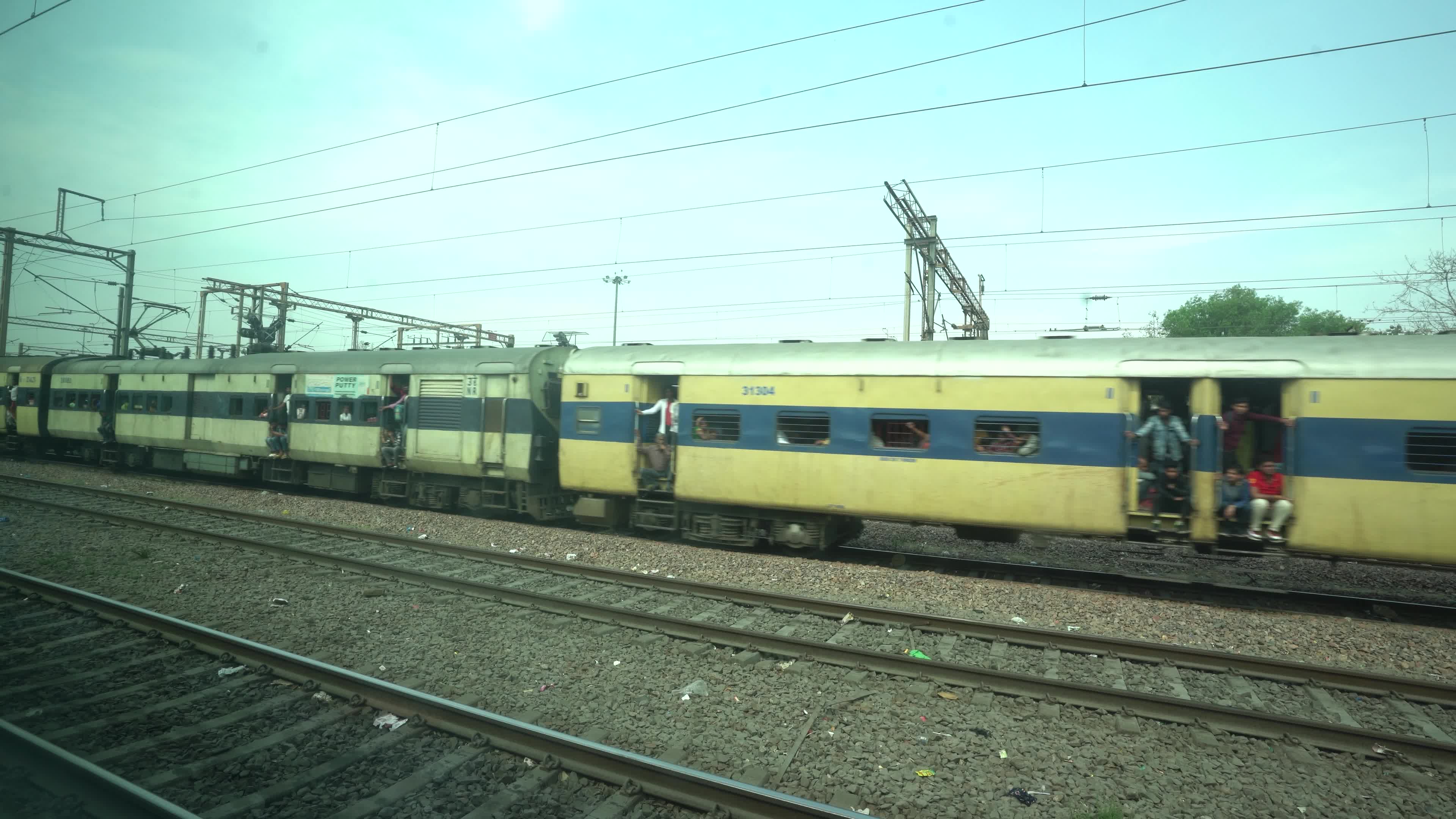 Views outside the window of a moving passenger train of Indian Railways in India