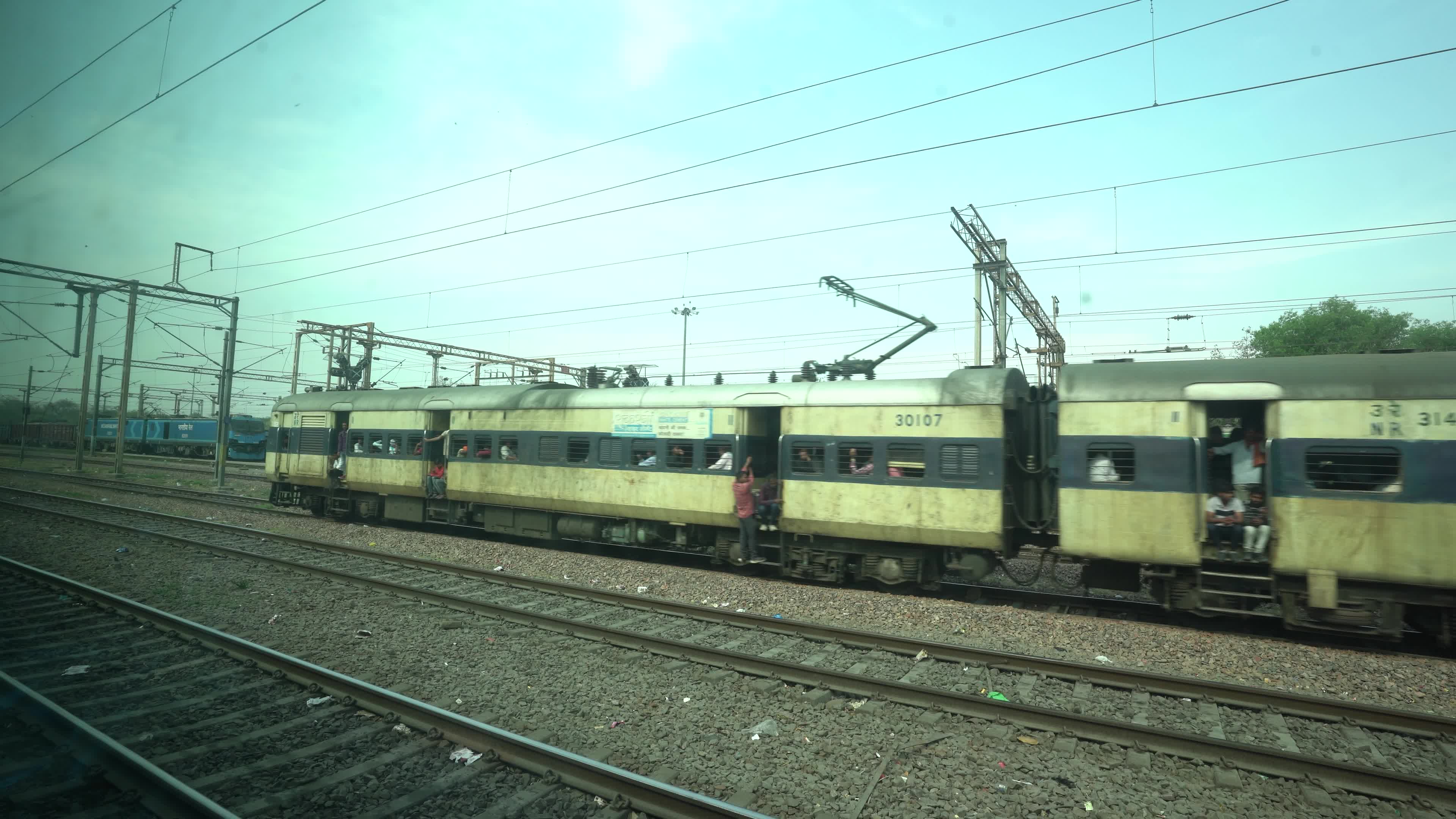 Views outside the window of a moving passenger train of Indian Railways in India