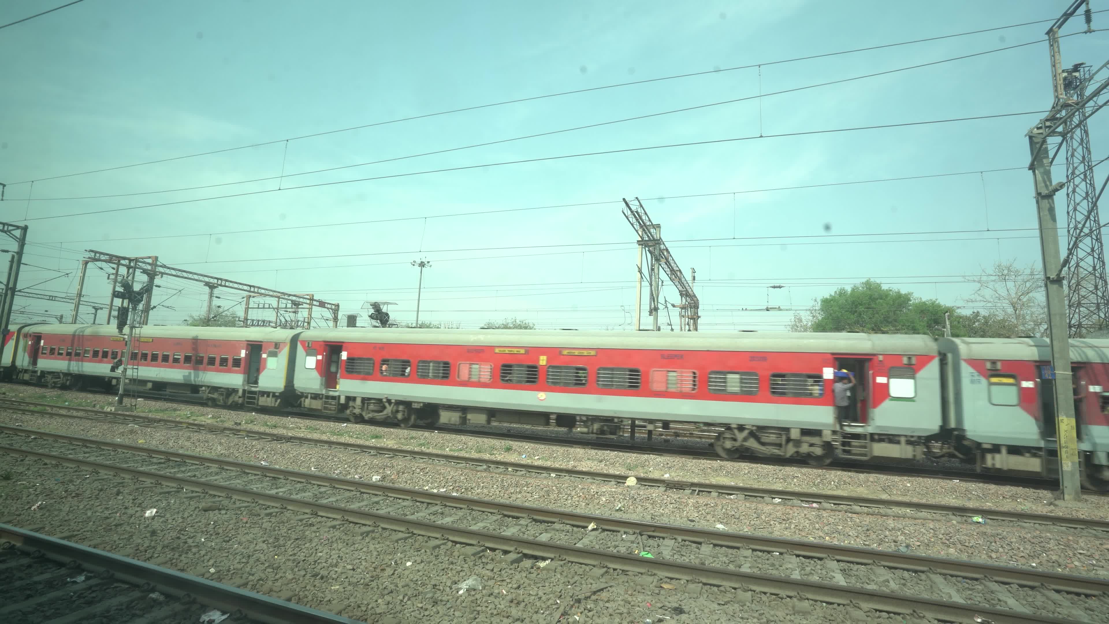 Views outside the window of a moving passenger train of Indian Railways in India