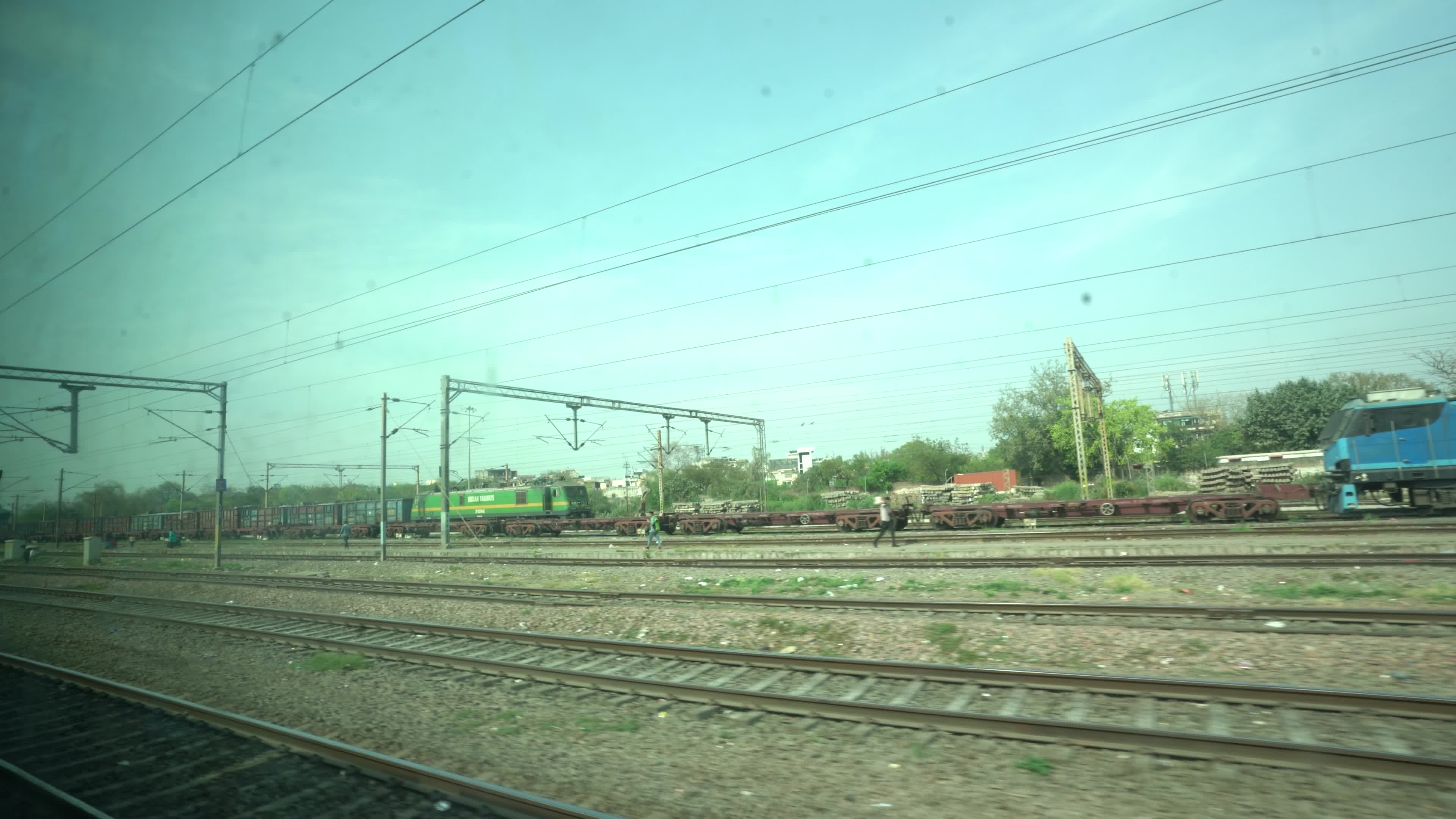 Views outside the window of a moving passenger train of Indian Railways in India