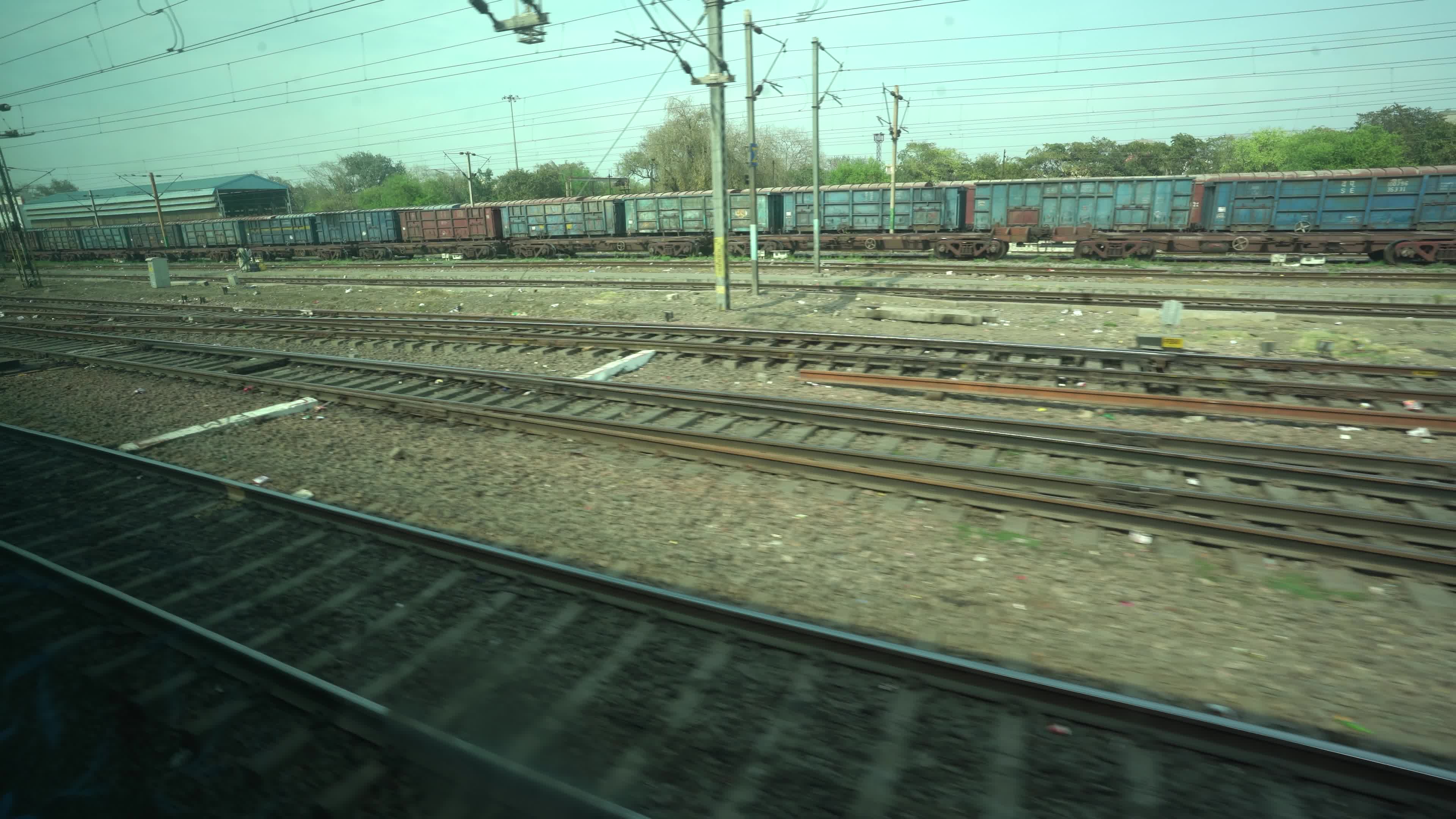 Views outside the window of a moving passenger train of Indian Railways in India