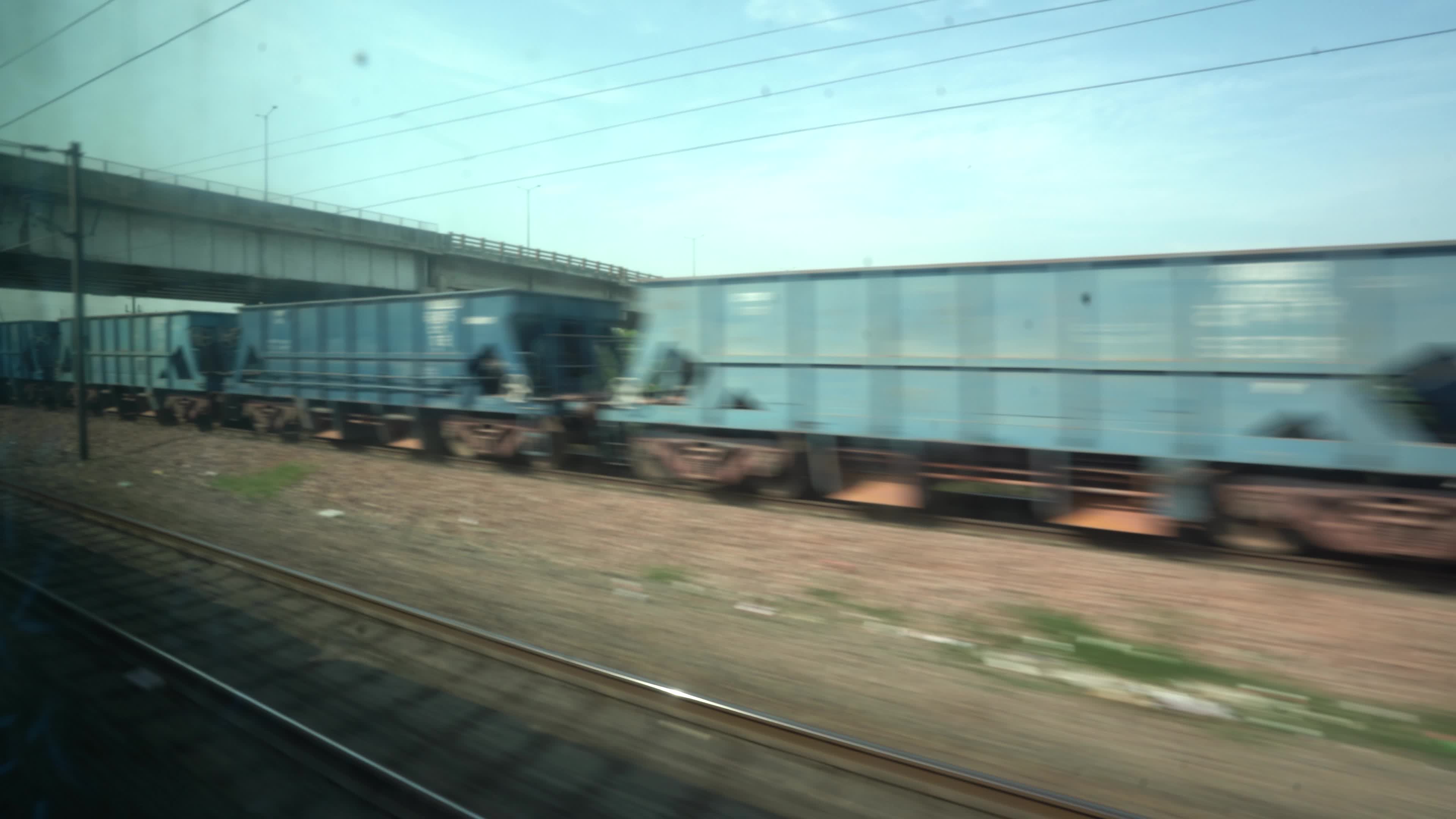 Views outside the window of a moving passenger train of Indian Railways in India