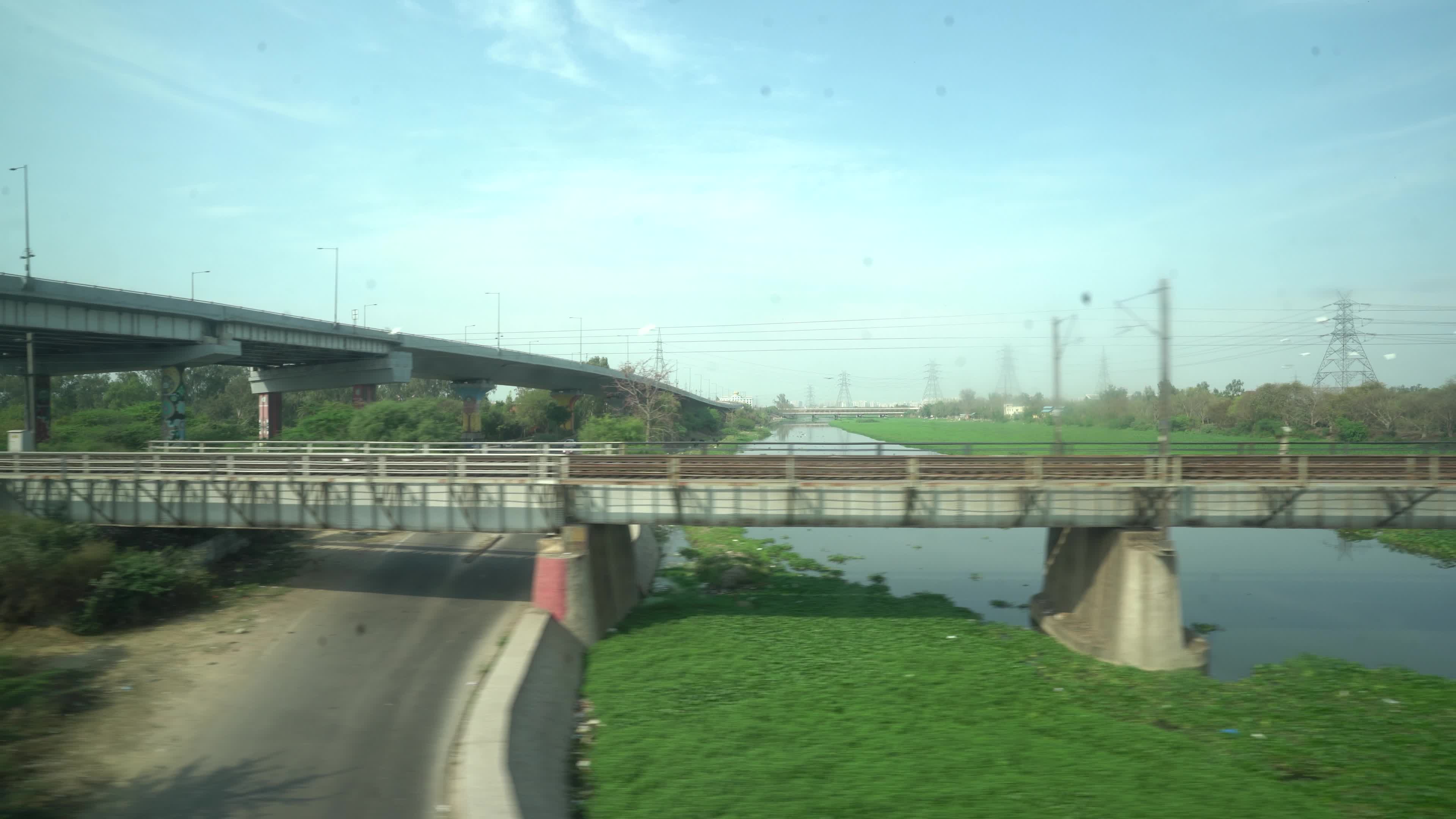 Views outside the window of a moving passenger train of Indian Railways in India