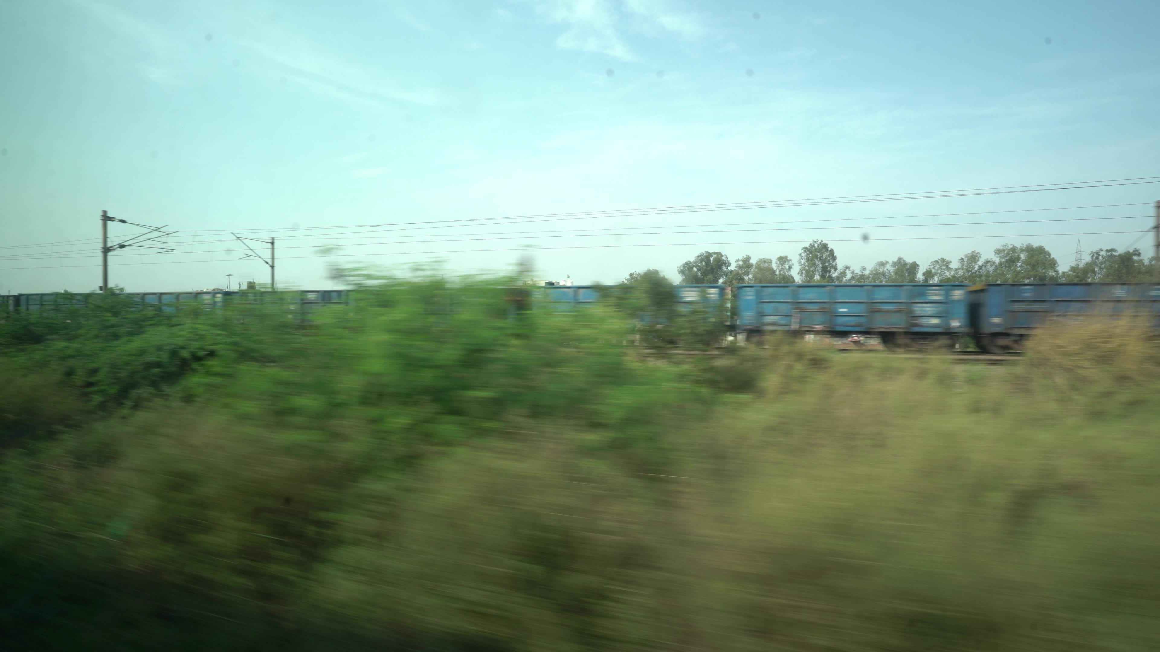 Views outside the window of a moving passenger train of Indian Railways in India