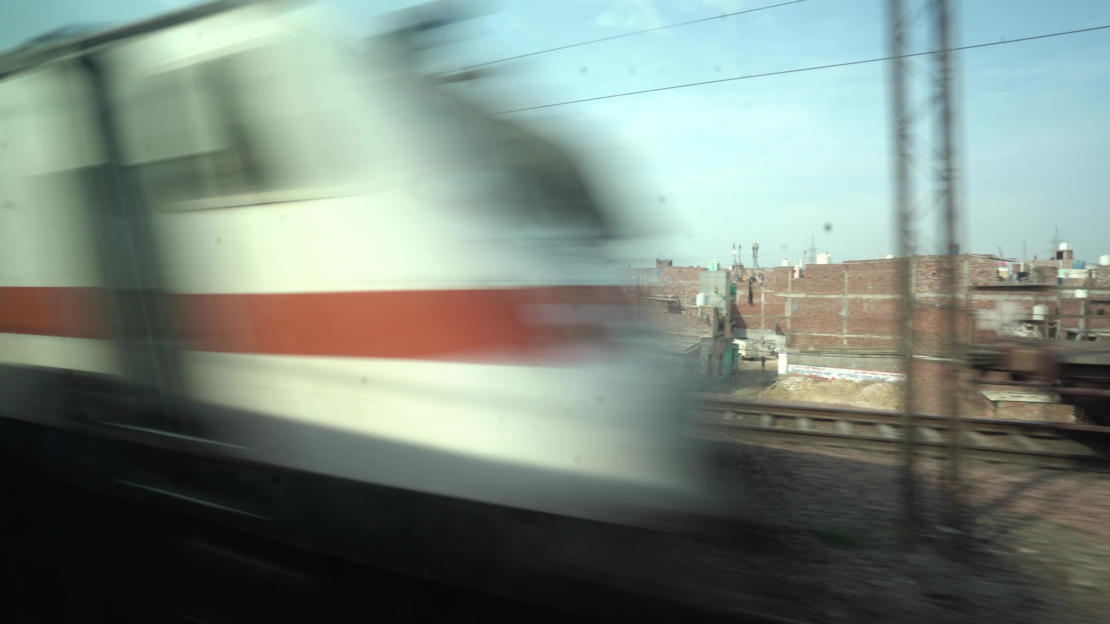 Views outside the window of a moving passenger train of Indian Railways in India
