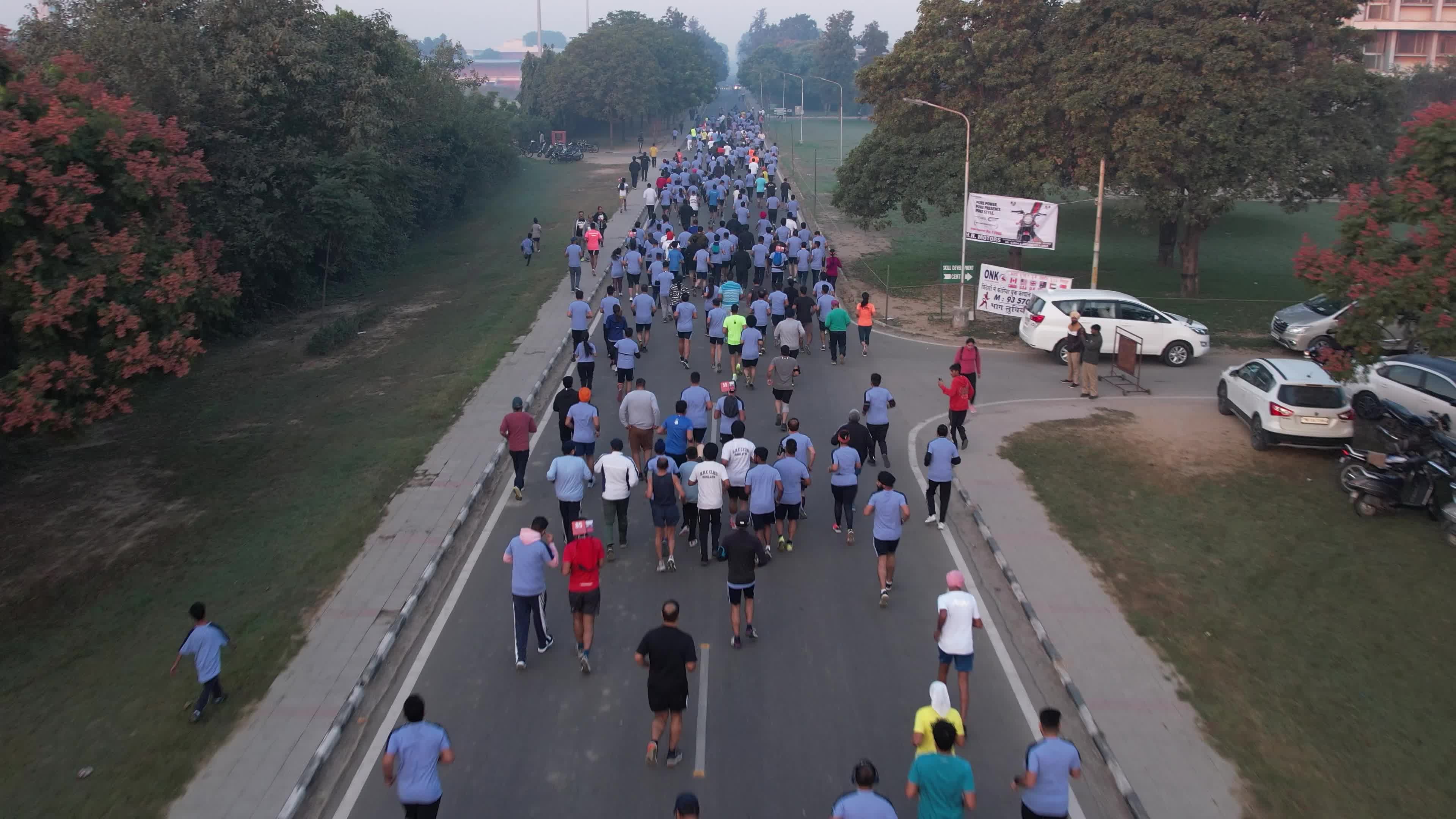 Marathon Madness in Ludhiana: 4K Drone Video of Runners on Tree-lined Streets