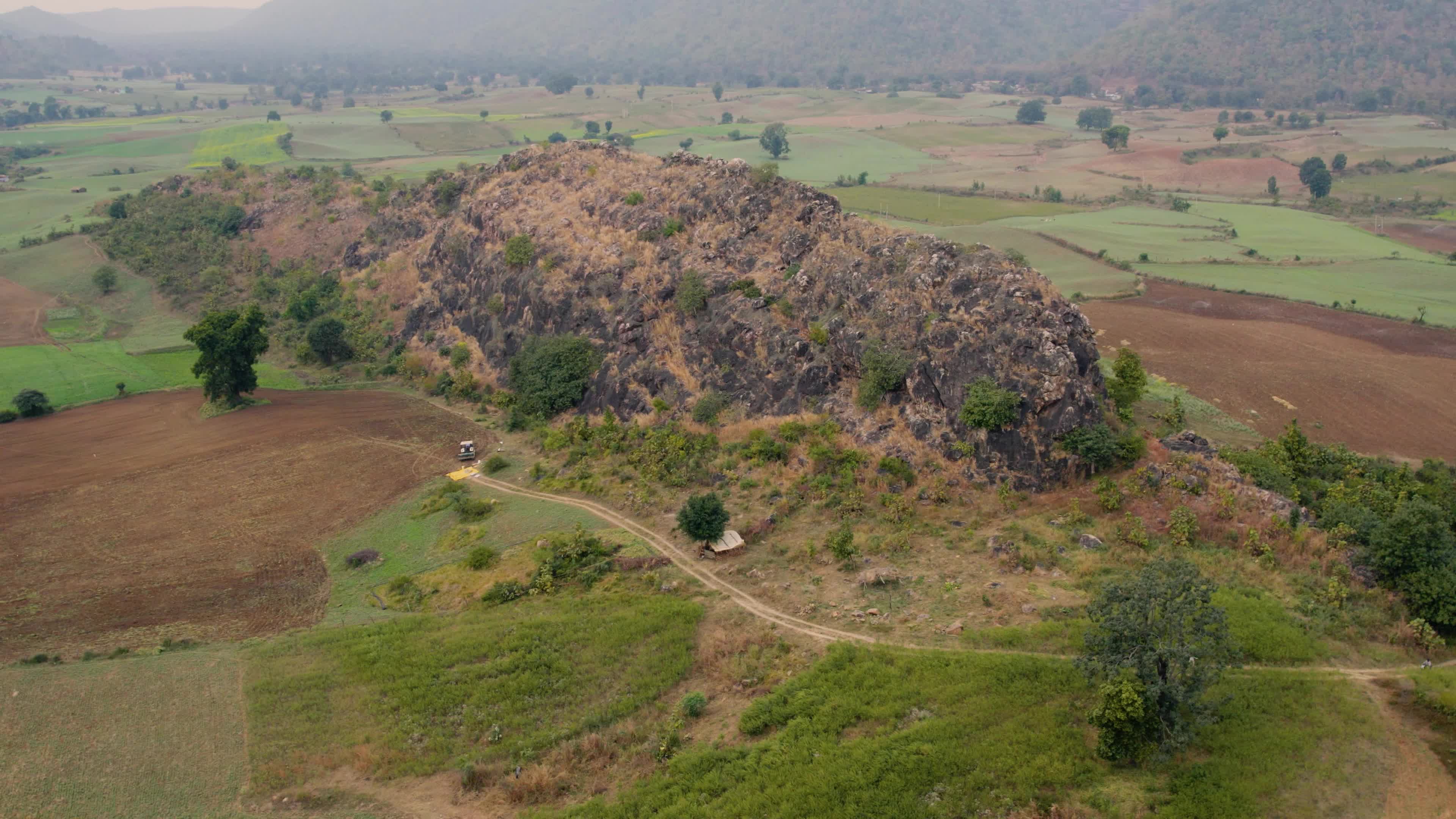 Beautiful drone view of a River surrounded by mountains and fields in the Indian state of Chhattisgarh