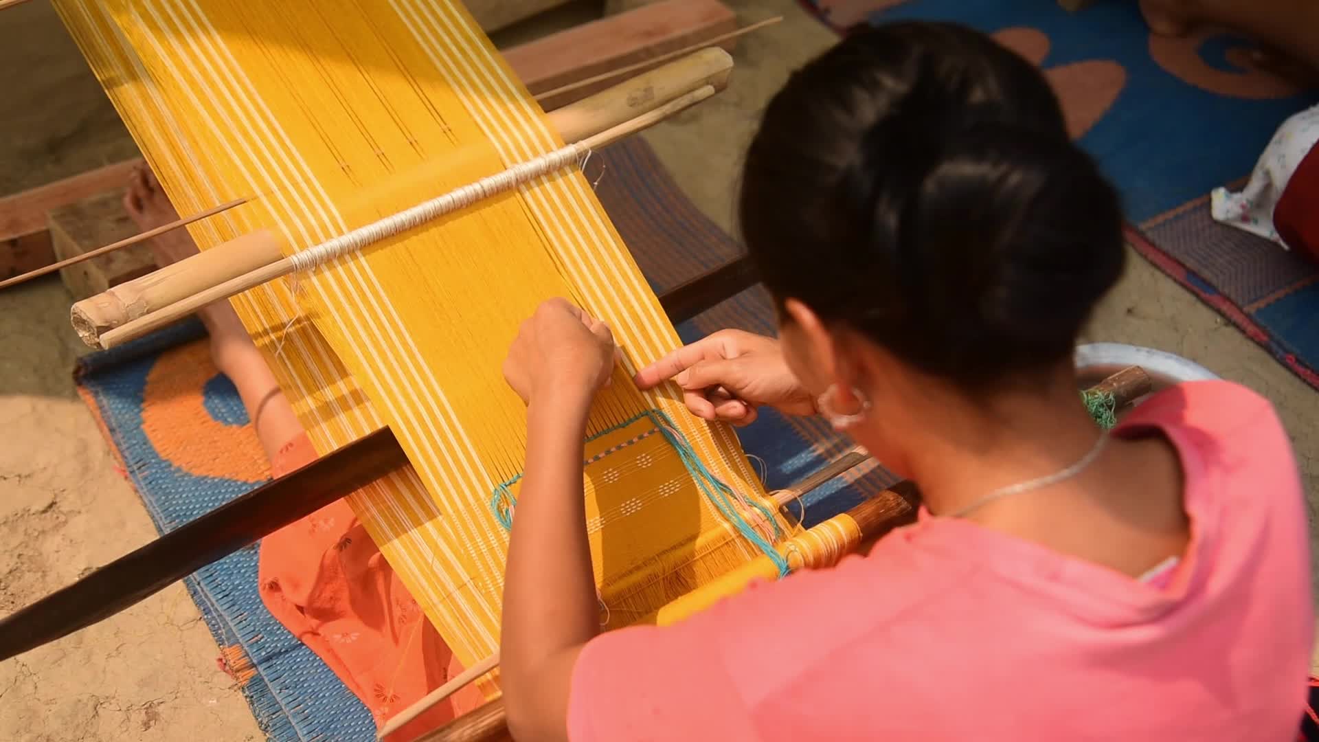 Tribal women weaving traditional Jamborong in India 