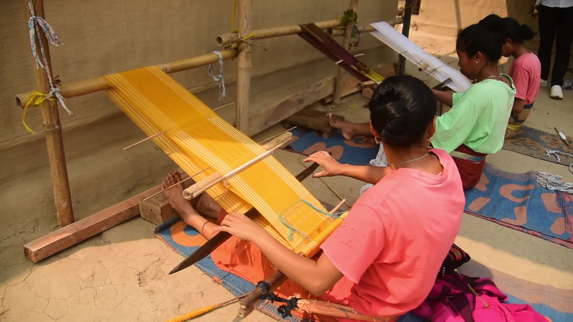 Tribal women weaving traditional Jamborong in India 