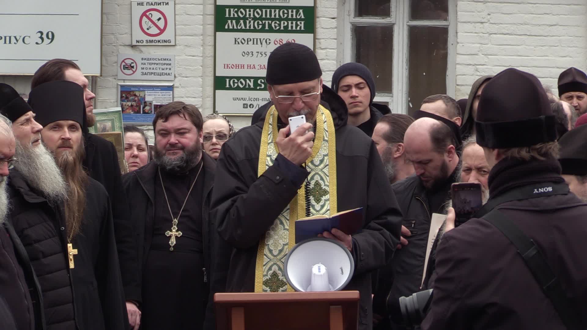 Believers pray and block the acess at an entry to Kyiv-Pechersk Lavra despite lease agreement expired, amid Russia's invasion of Ukraine