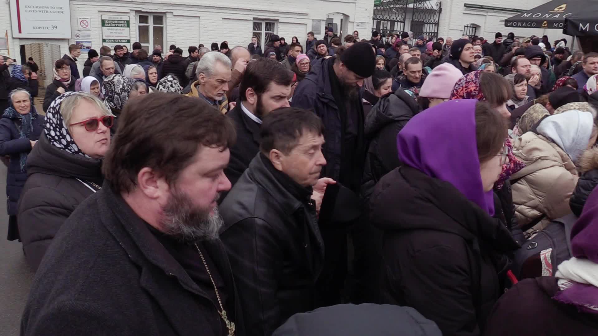 Believers pray and block the acess at an entry to Kyiv-Pechersk Lavra despite lease agreement expired, amid Russia's invasion of Ukraine