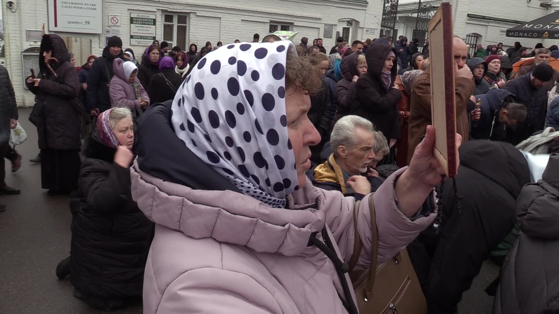 Believers pray and block the acess at an entry to Kyiv-Pechersk Lavra despite lease agreement expired, amid Russia's invasion of Ukraine