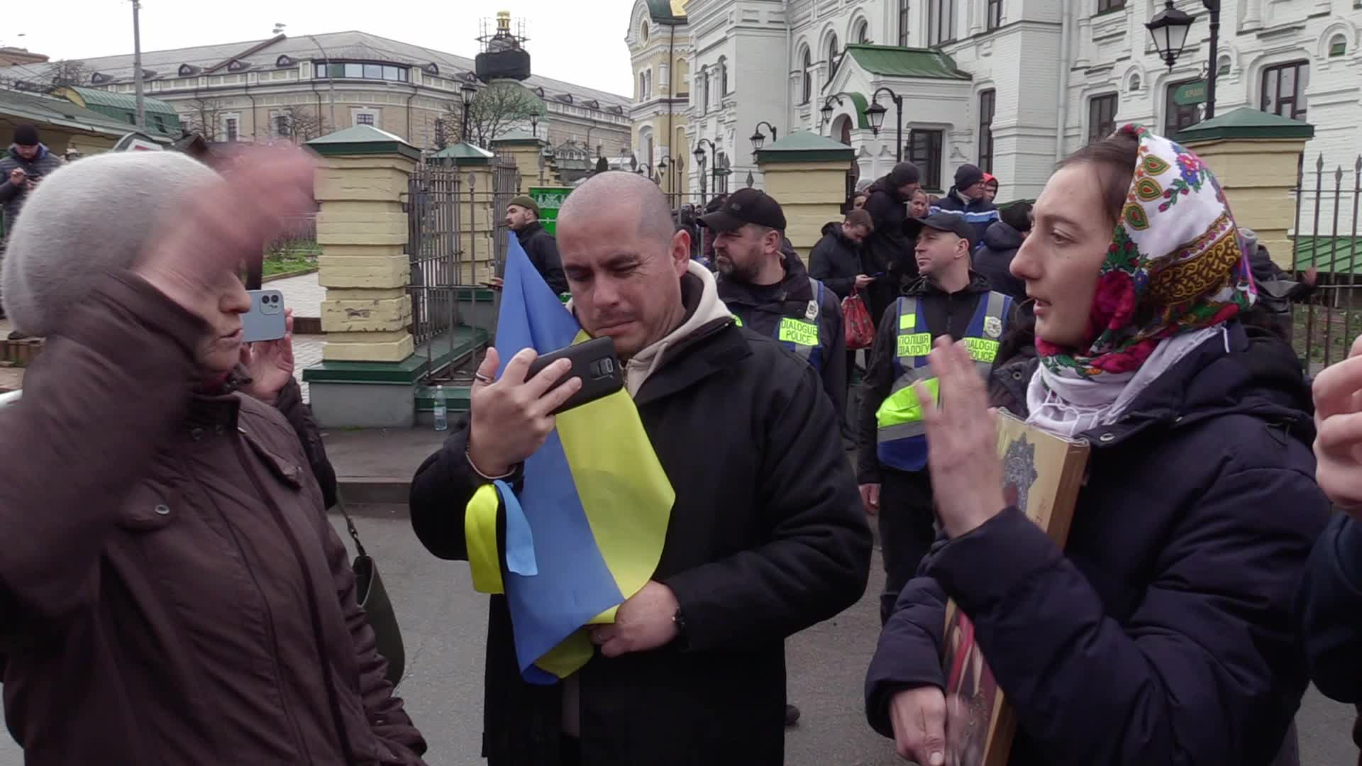 Believers pray and block the acess at an entry to Kyiv-Pechersk Lavra despite lease agreement expired, amid Russia's invasion of Ukraine
