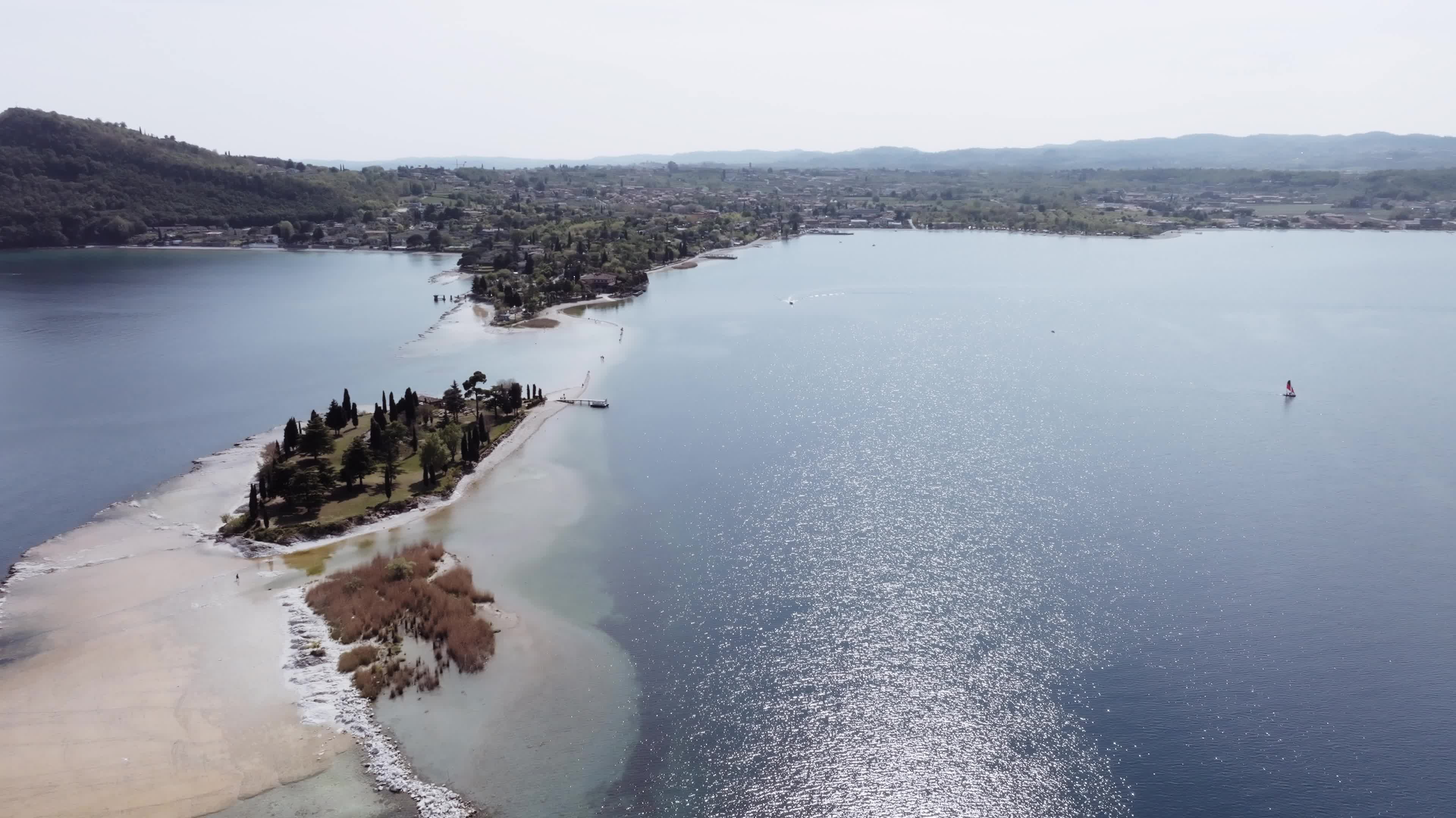 Drone View: Tourists Flock to Lake Garda Island, Reconnected Due to Drought