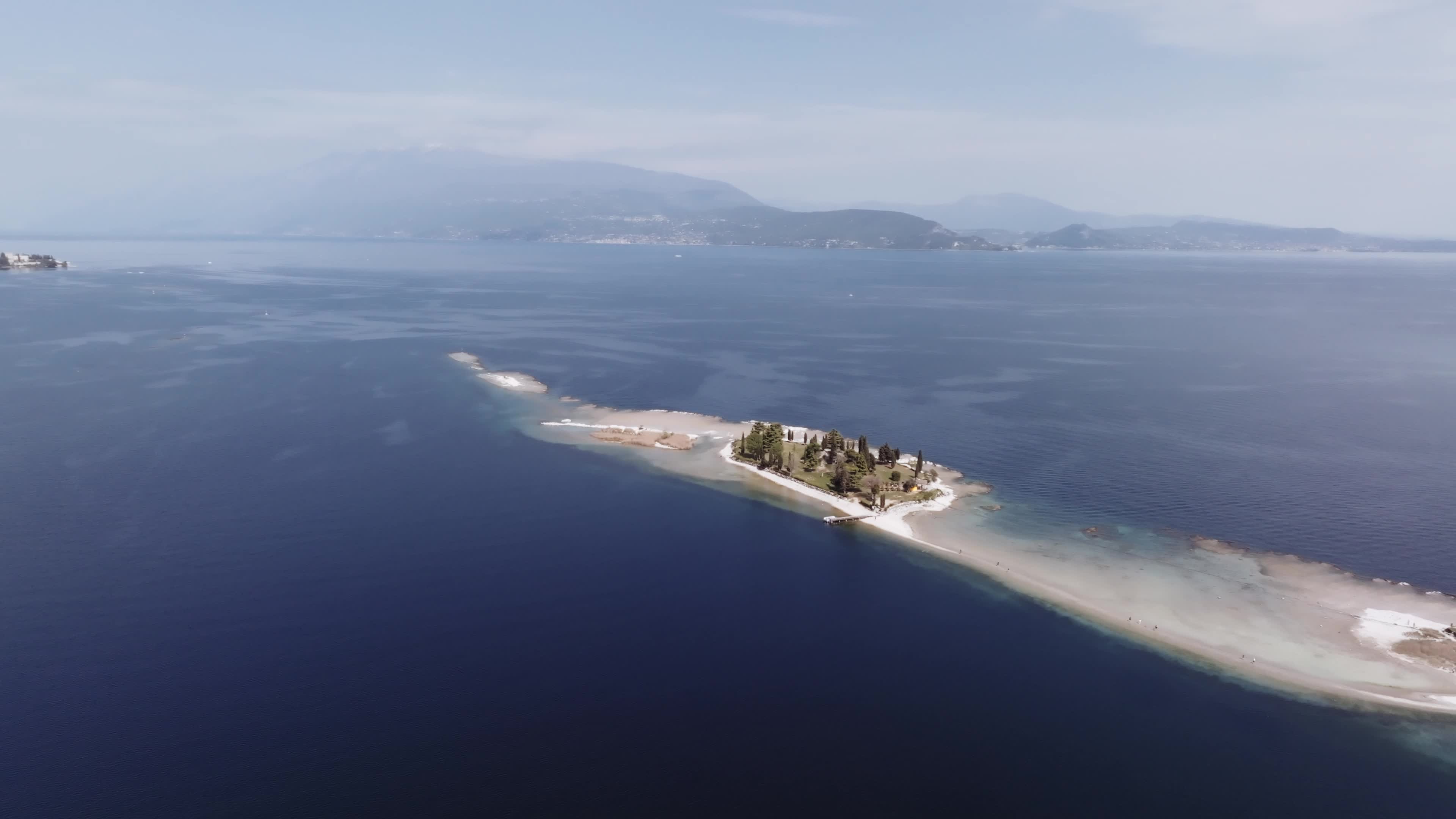 Drone View: Tourists Flock to Lake Garda Island, Reconnected Due to Drought