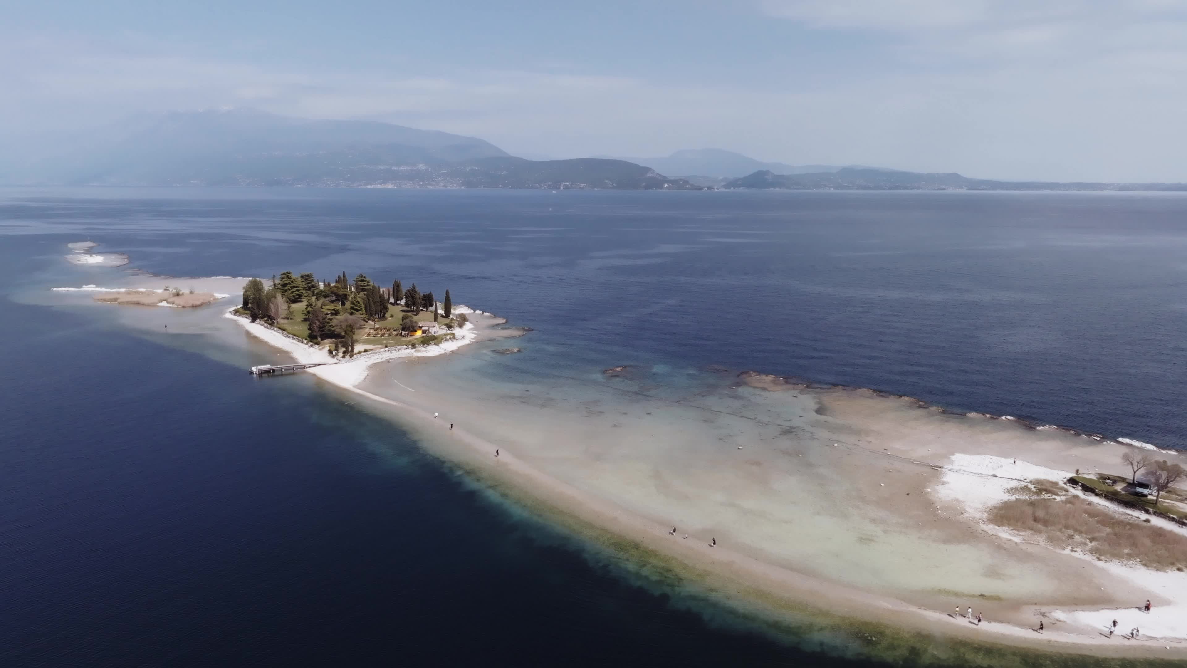 Drone View: Tourists Flock to Lake Garda Island, Reconnected Due to Drought