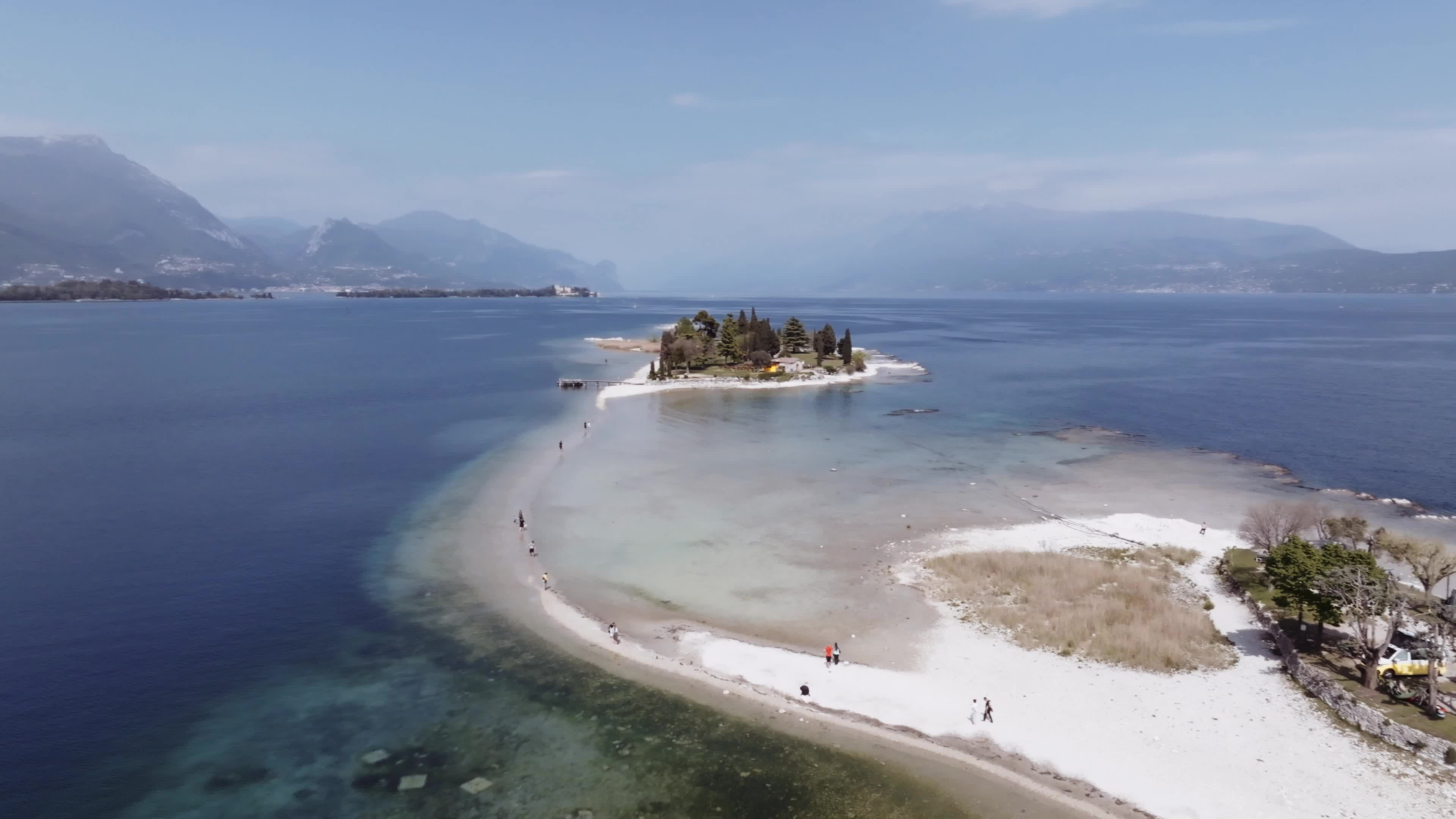 Drone View: Tourists Flock to Lake Garda Island, Reconnected Due to Drought