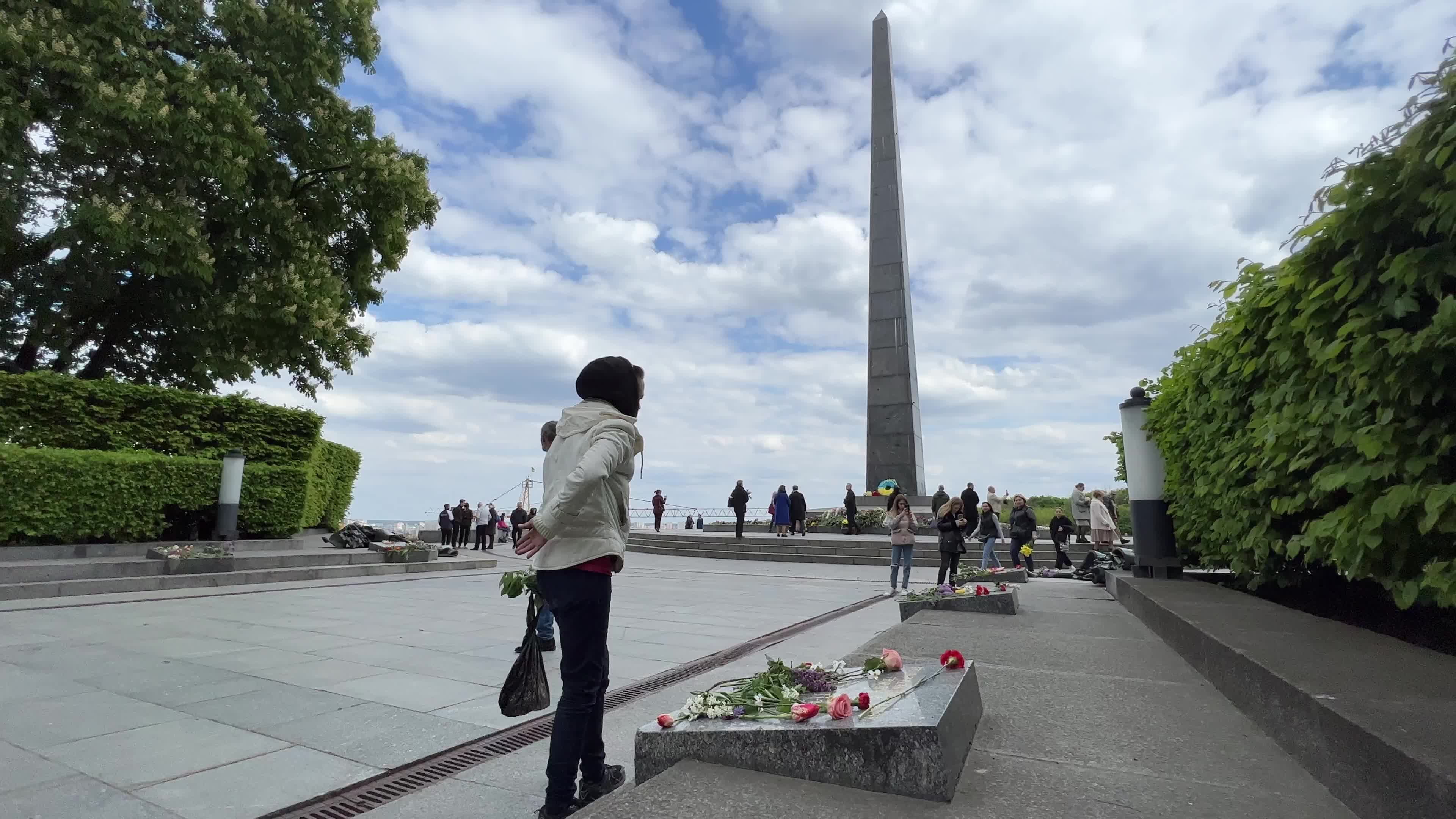 People place floral tributes at the Tomb of the Unknown Soldier monument during Victory in WWII Day commemorations in Kyiv 