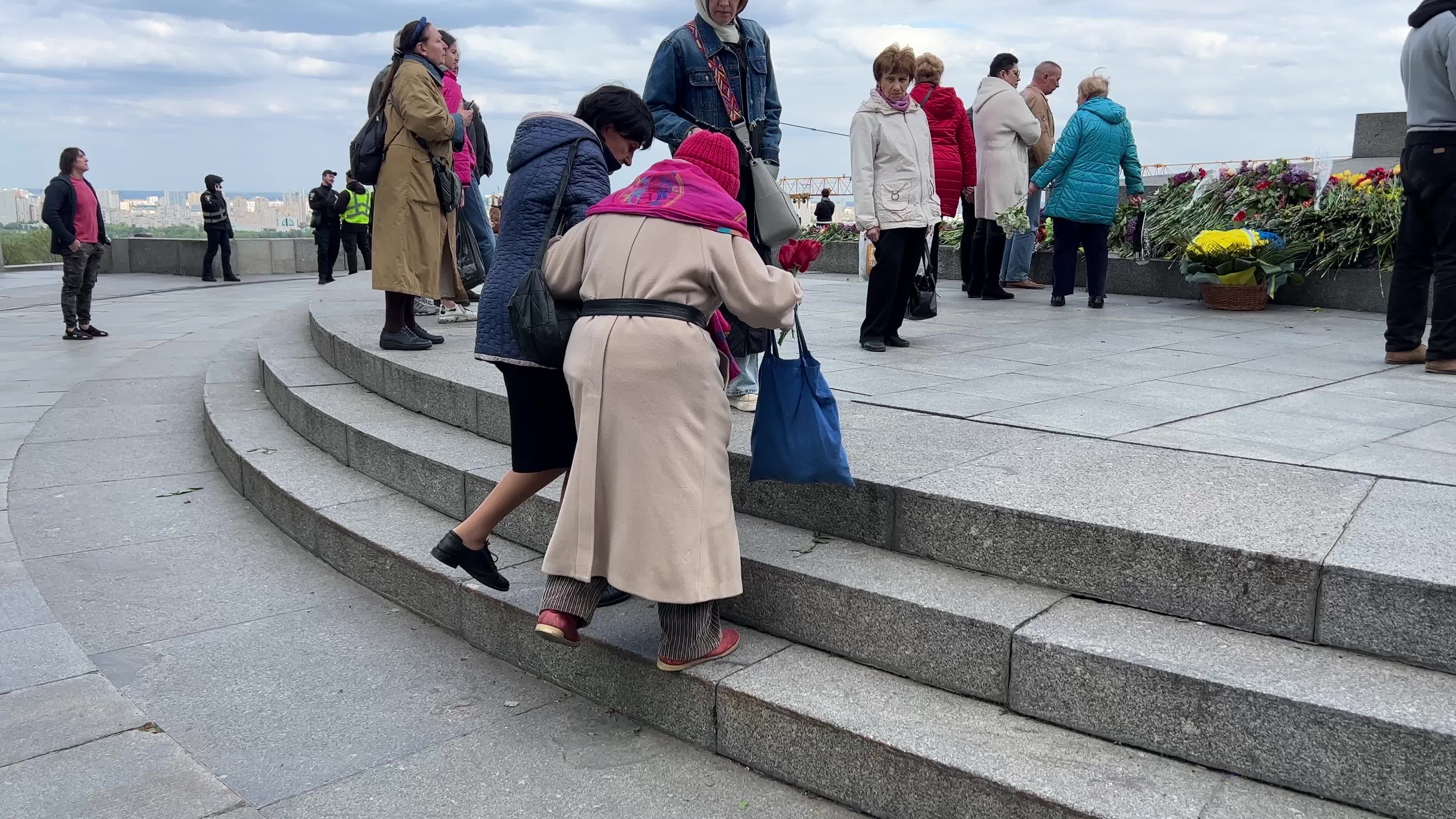 People place floral tributes at the Tomb of the Unknown Soldier monument during Victory in WWII Day commemorations in Kyiv 