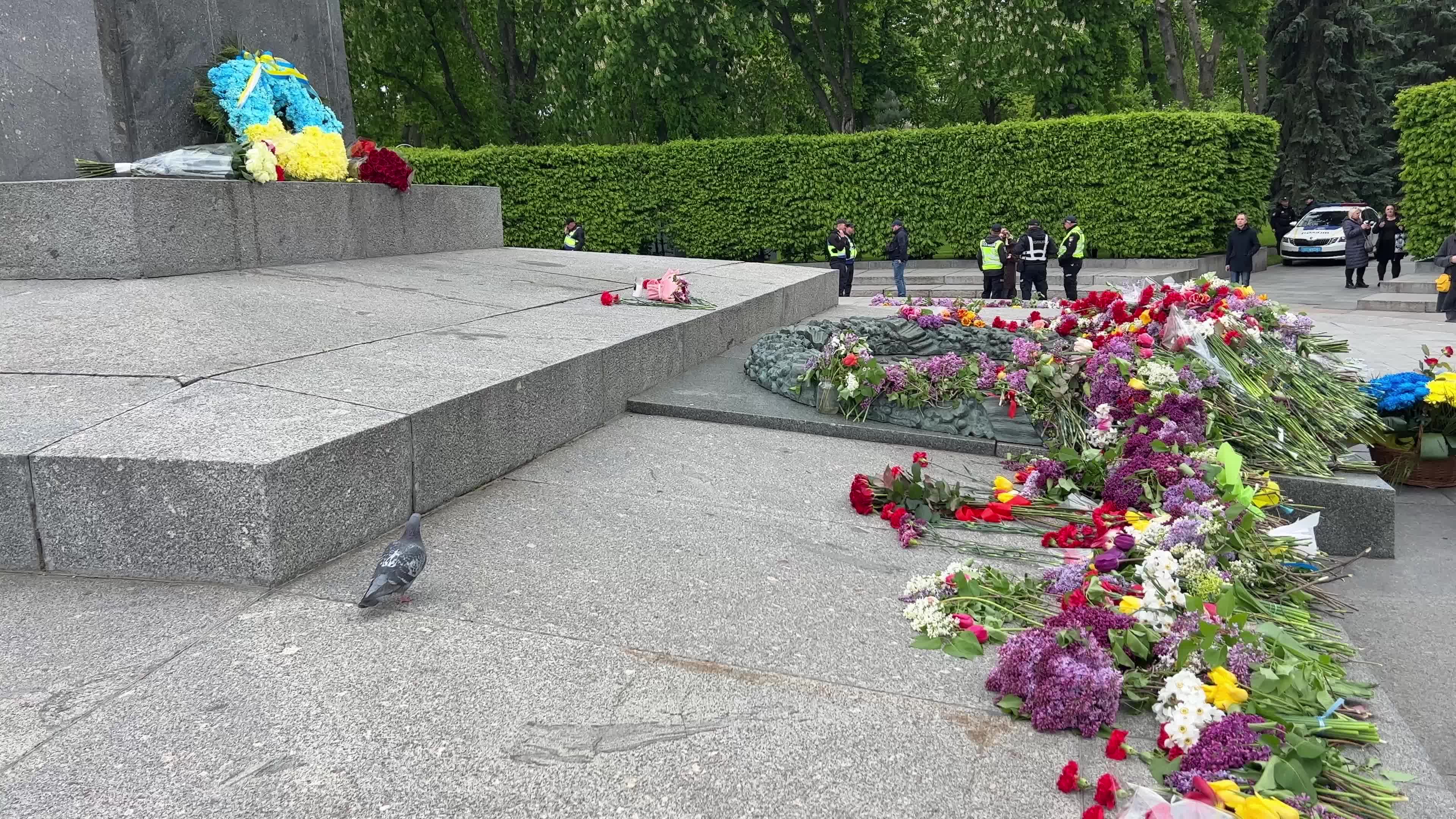 People place floral tributes at the Tomb of the Unknown Soldier monument during Victory in WWII Day commemorations in Kyiv 