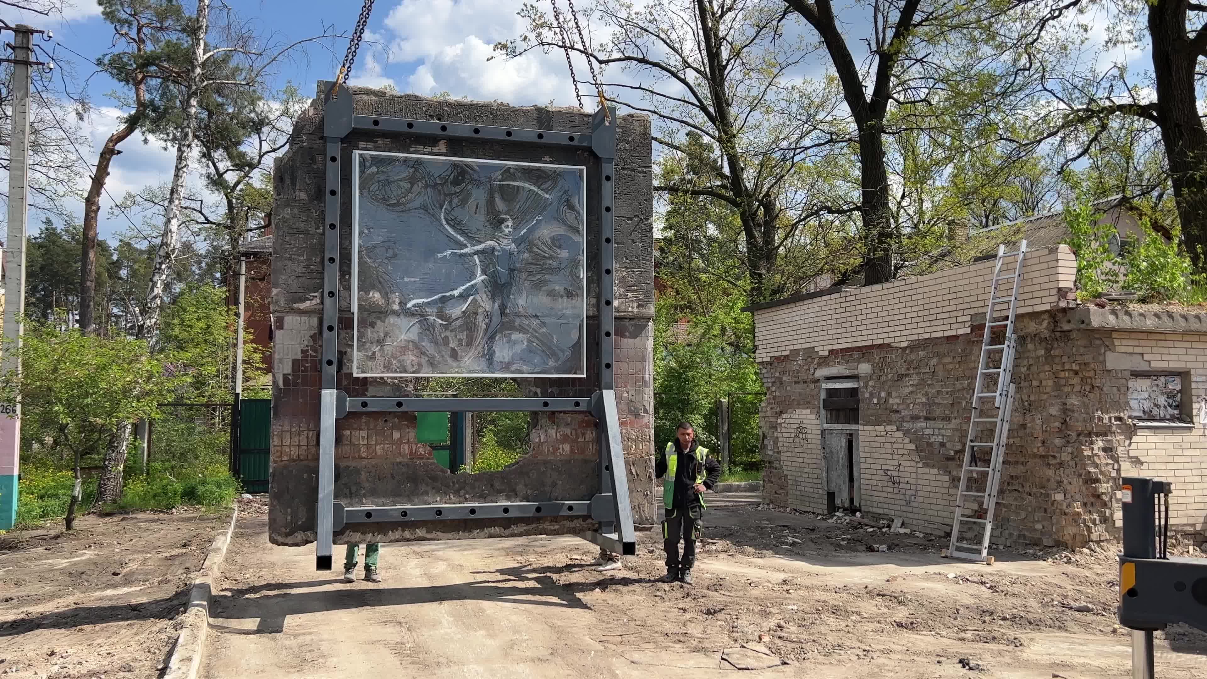 Part of a wall featuring the work of world-renowned graffiti artist Banksy is moved to a new location 