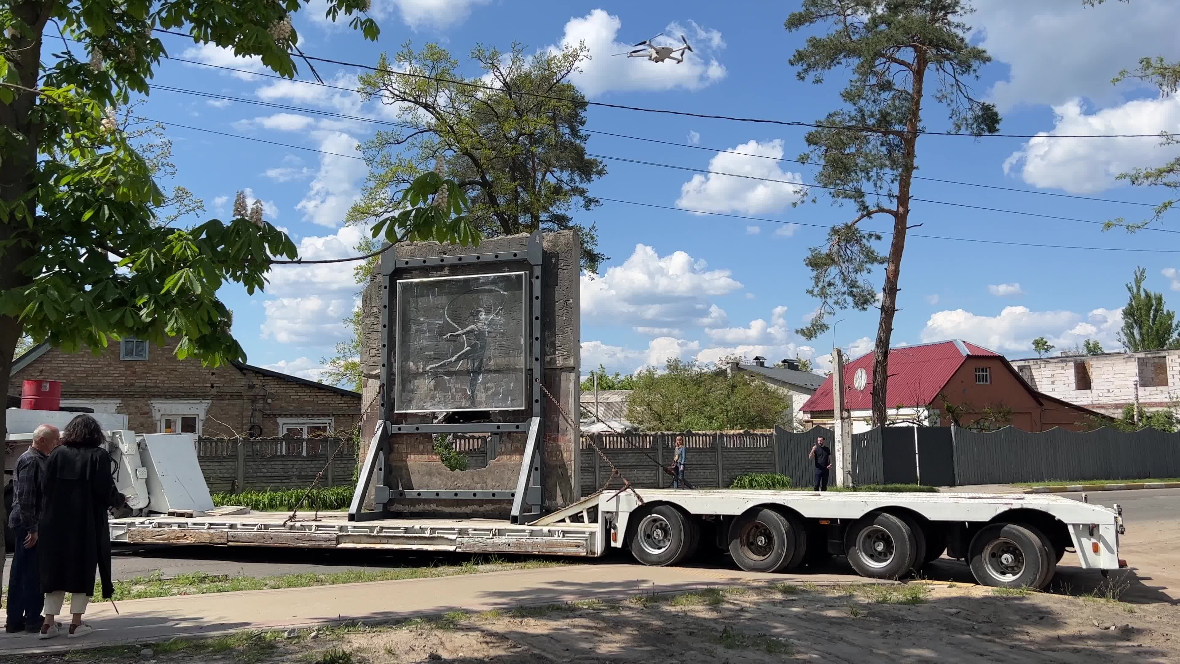 Part of a wall featuring the work of world-renowned graffiti artist Banksy is moved to a new location 