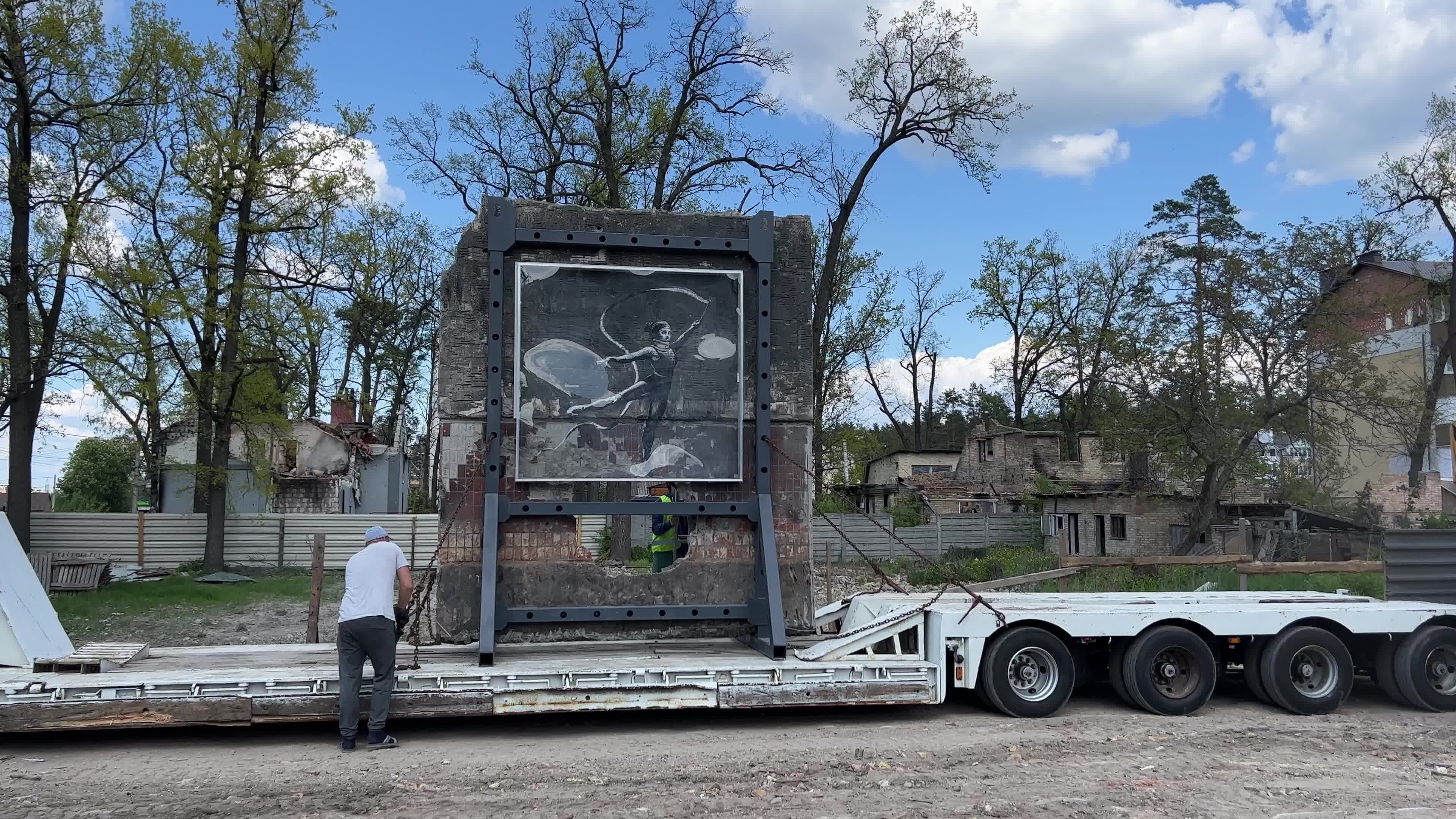 Part of a wall featuring the work of world-renowned graffiti artist Banksy is moved to a new location 