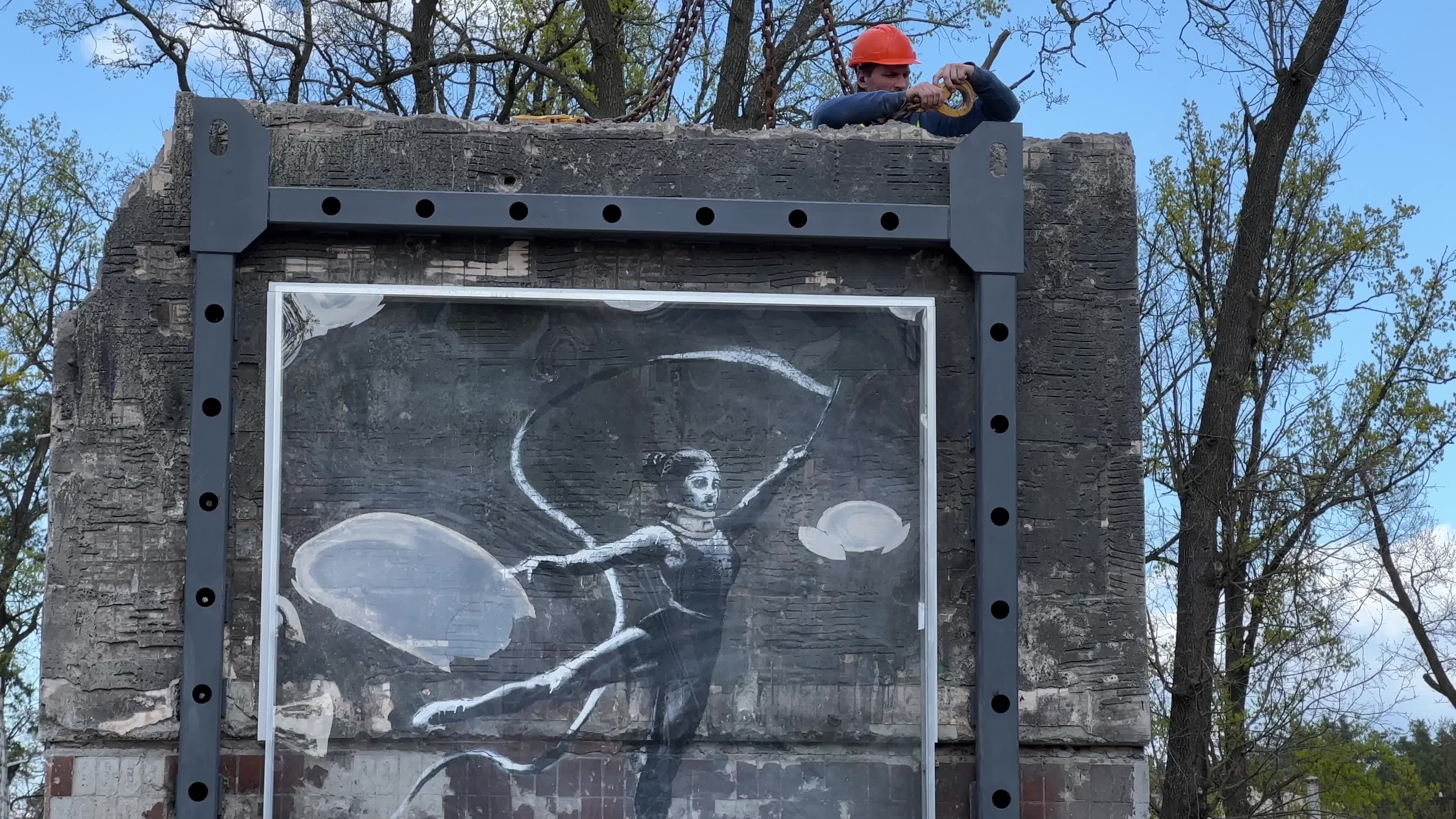 Part of a wall featuring the work of world-renowned graffiti artist Banksy is moved to a new location 