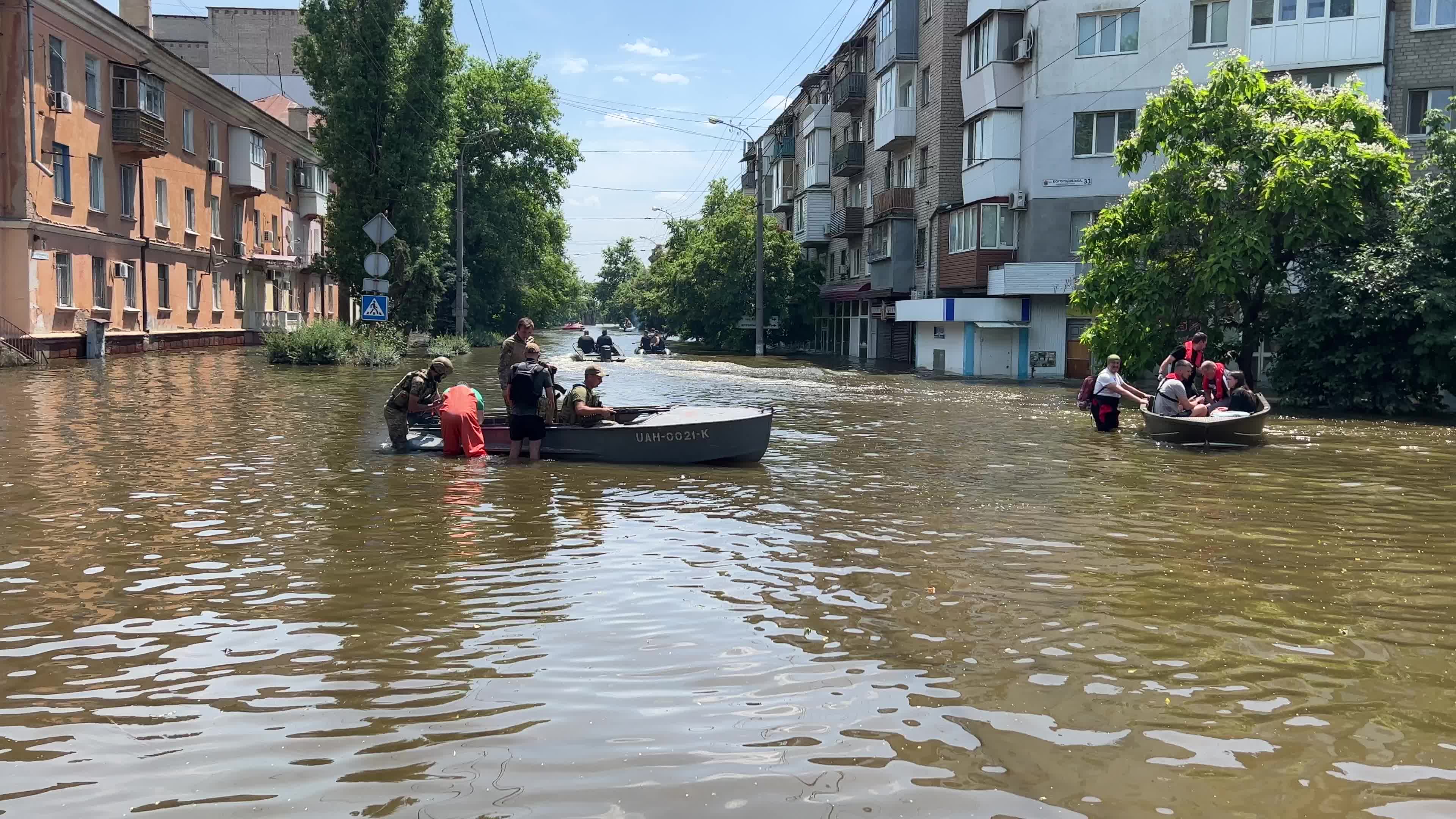 Rescuers, servicemen and volunteers evacuate local residents from a flooded area 