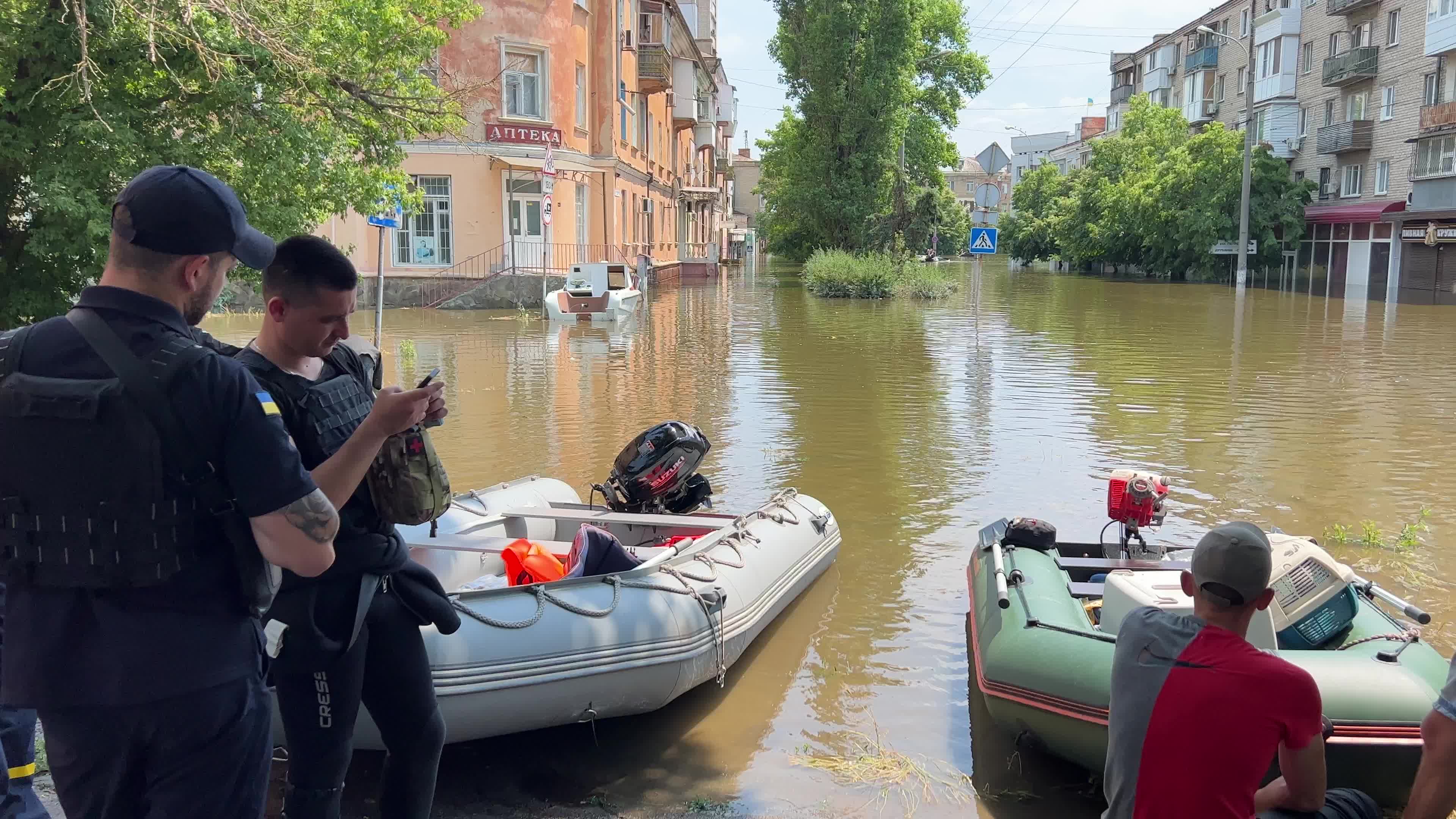 Rescuers, servicemen and volunteers evacuate local residents from a flooded area 