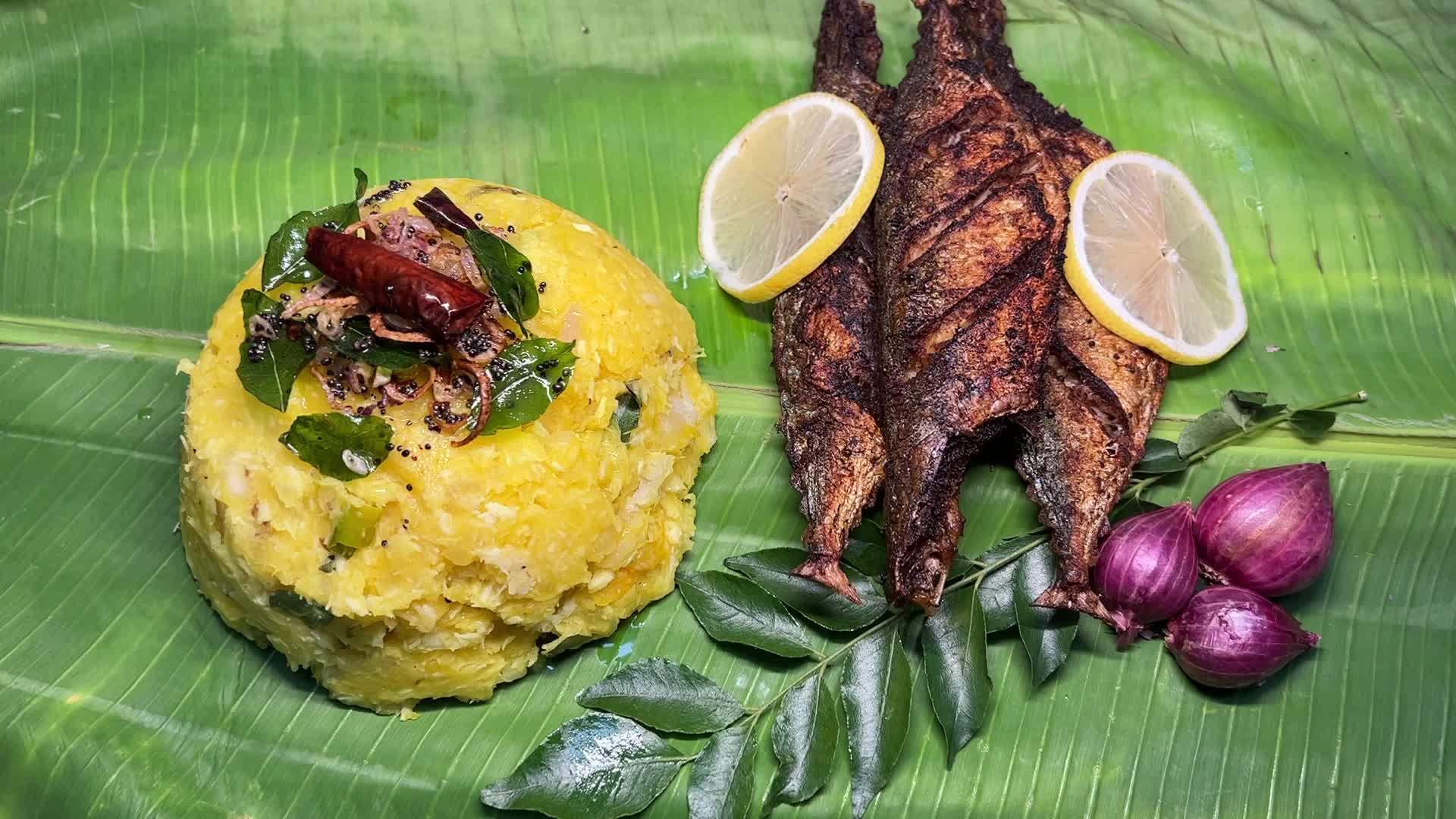 Kerala style fried fish with tapioca served on banana leaf