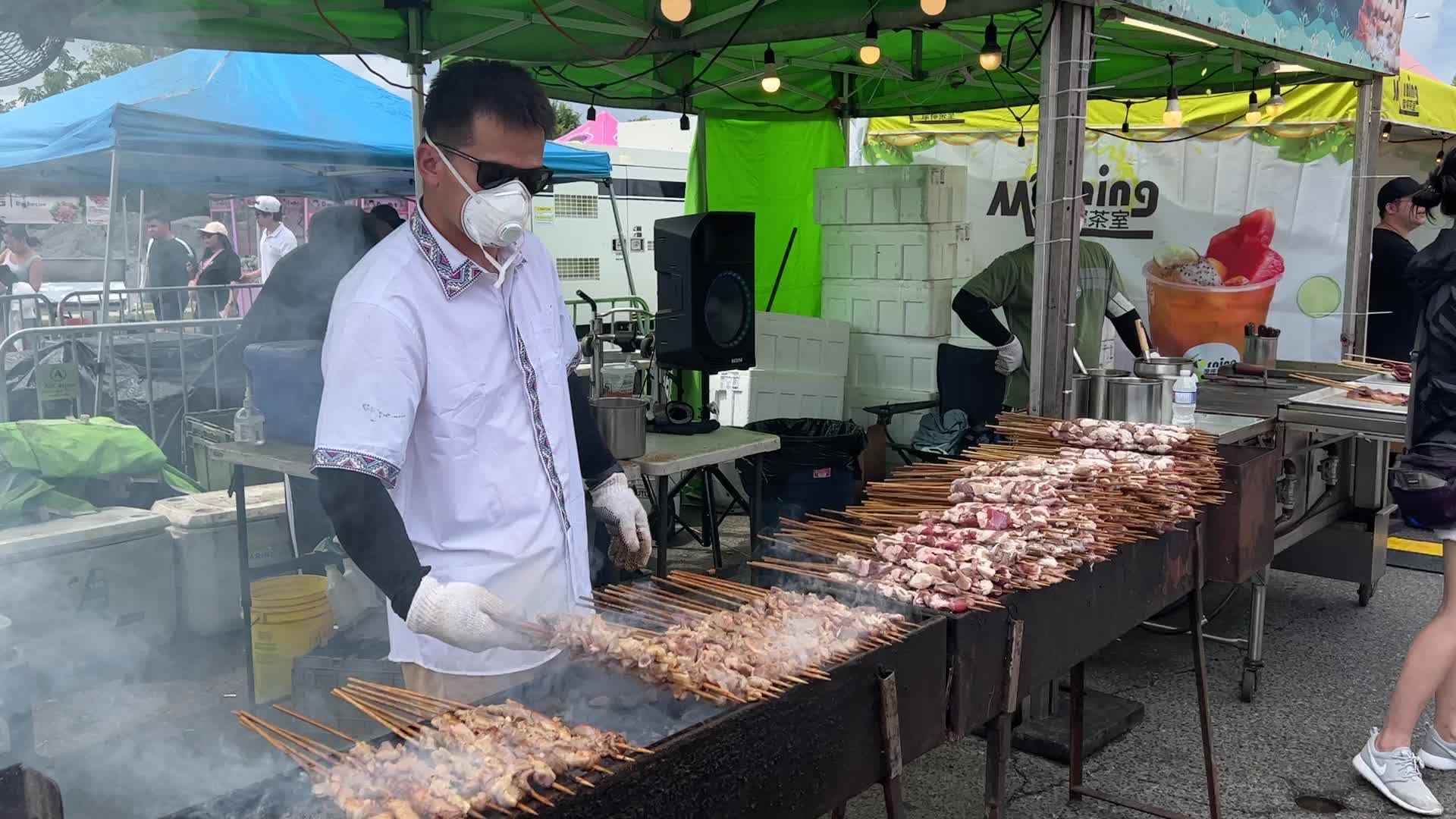 Man grills lamb skewers