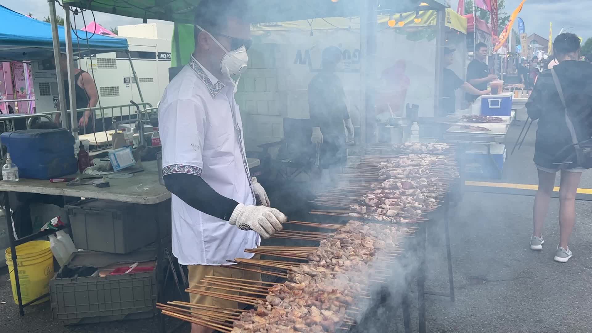 Man grills lamb skewers
