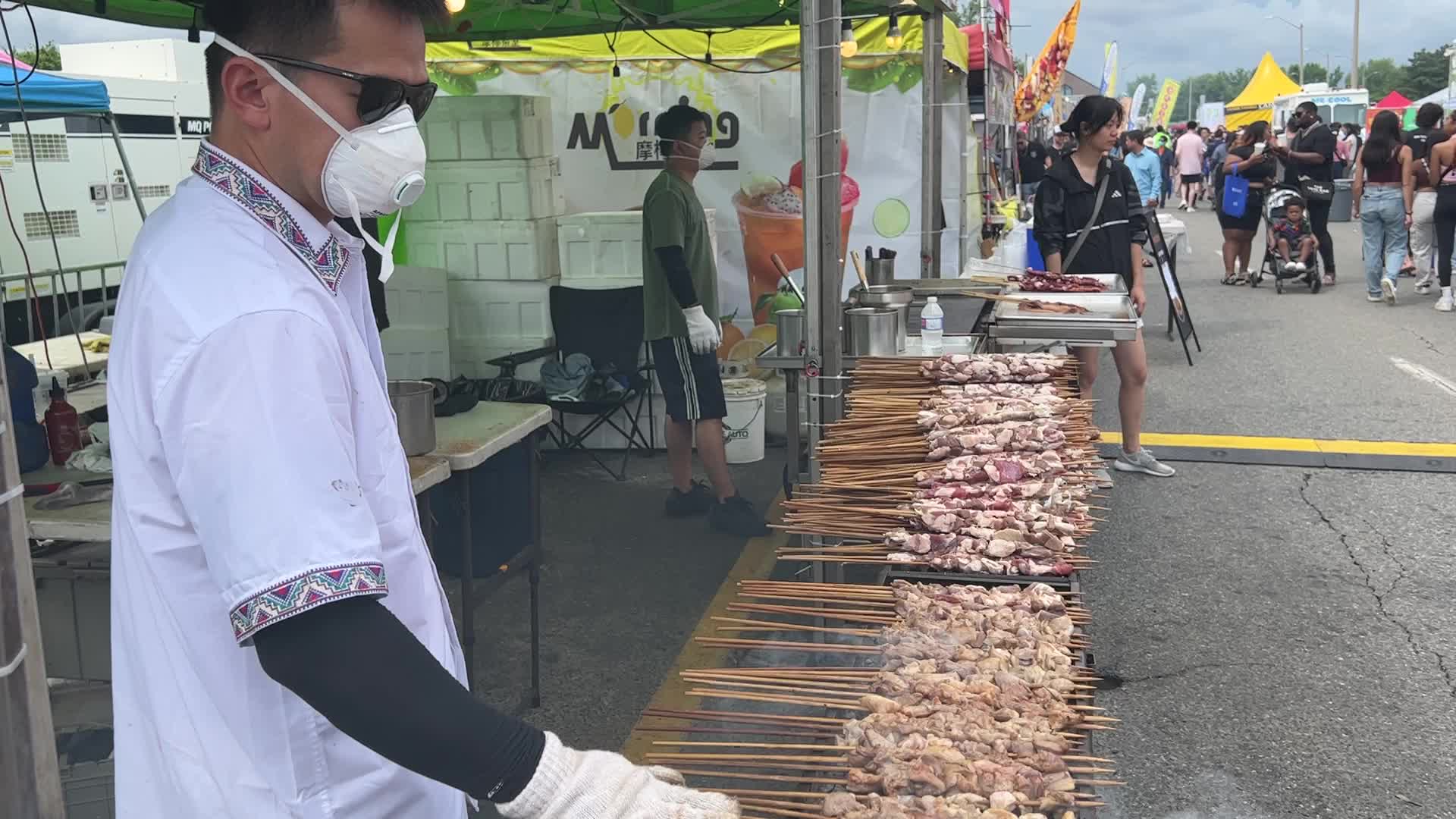 Man grills lamb skewers