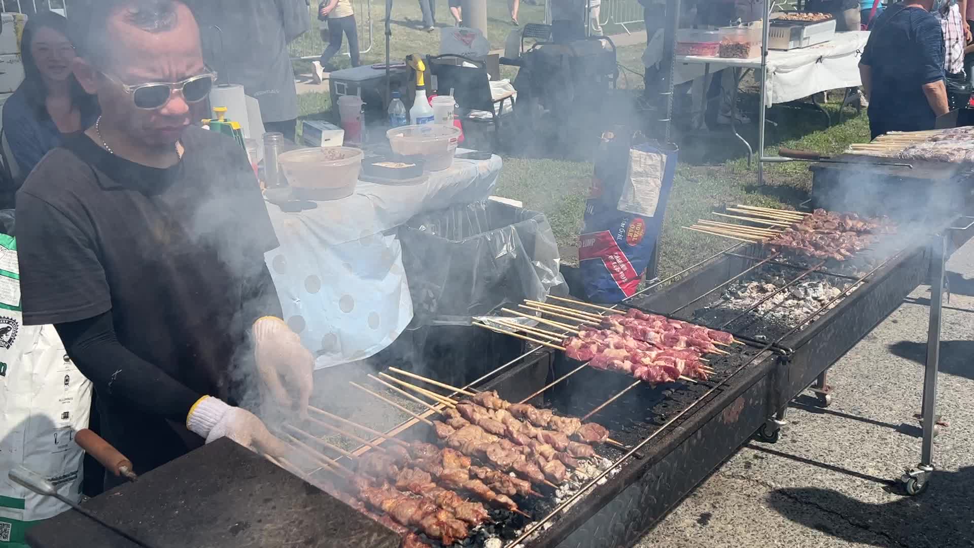 Man grills lamb skewers