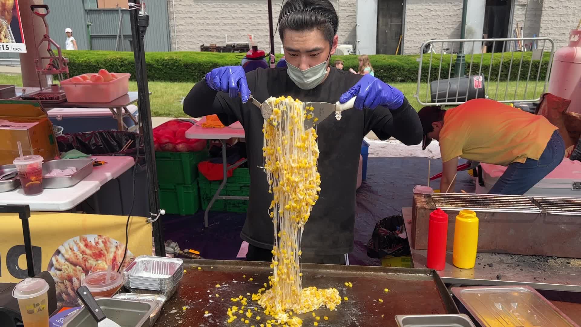Man prepares a snack consisting of corn kernels with melted cheese