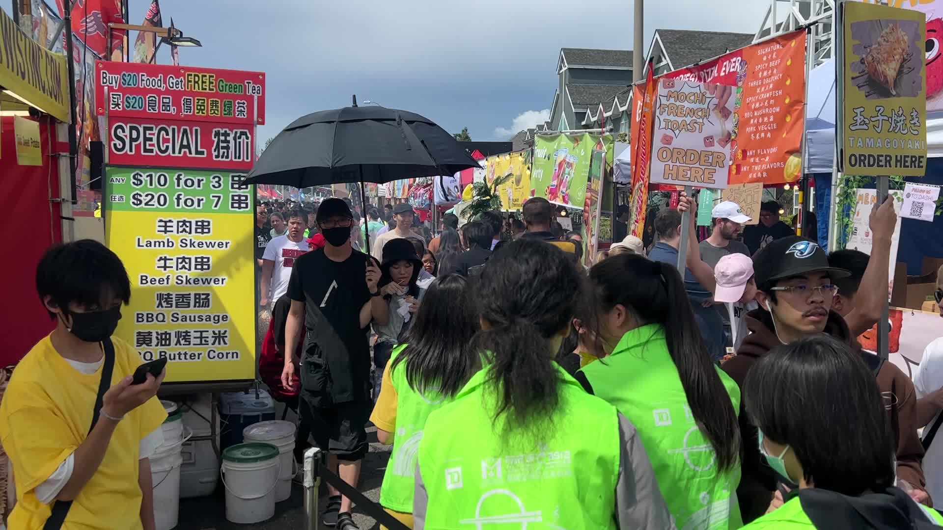 People prepare tornado potatoes during the Taste of Asia Food Festival