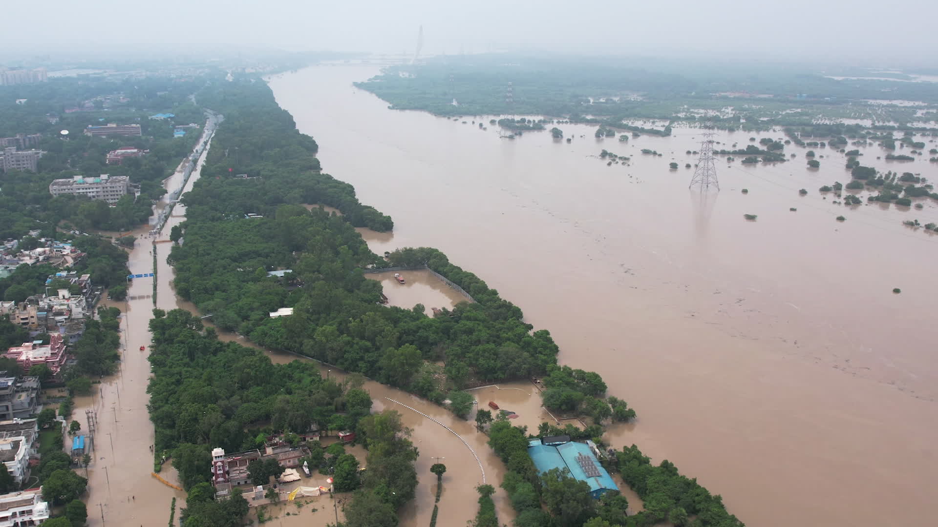 Drone view of flooded streets in New Delhi near Yamuna River.
