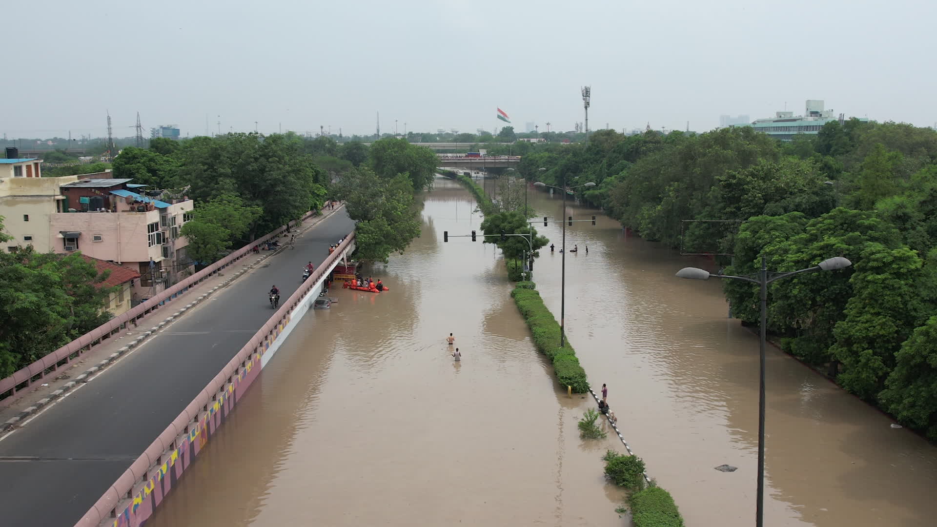 Drone view of flooded streets in New Delhi near Yamuna River.