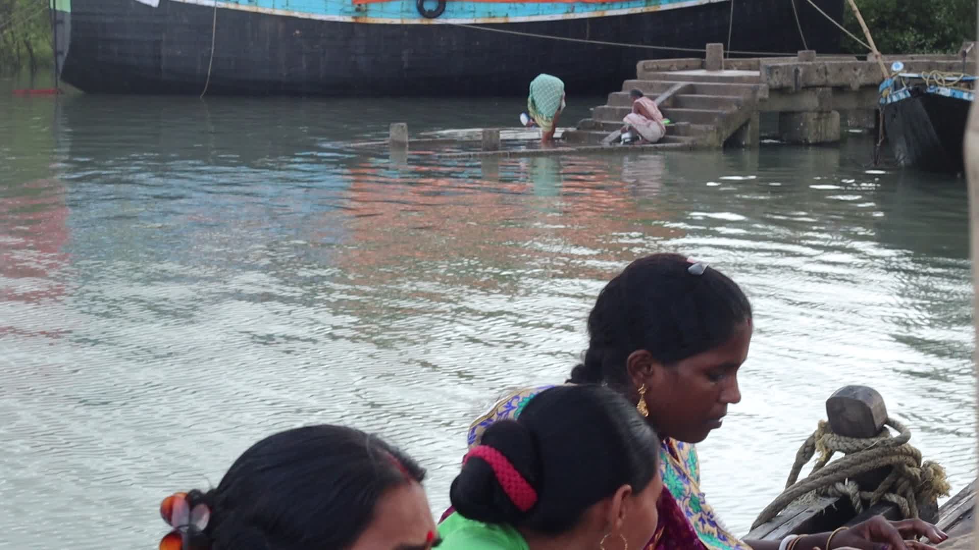 Villagers are crossing river Chenai by boat at Sunderbans delta