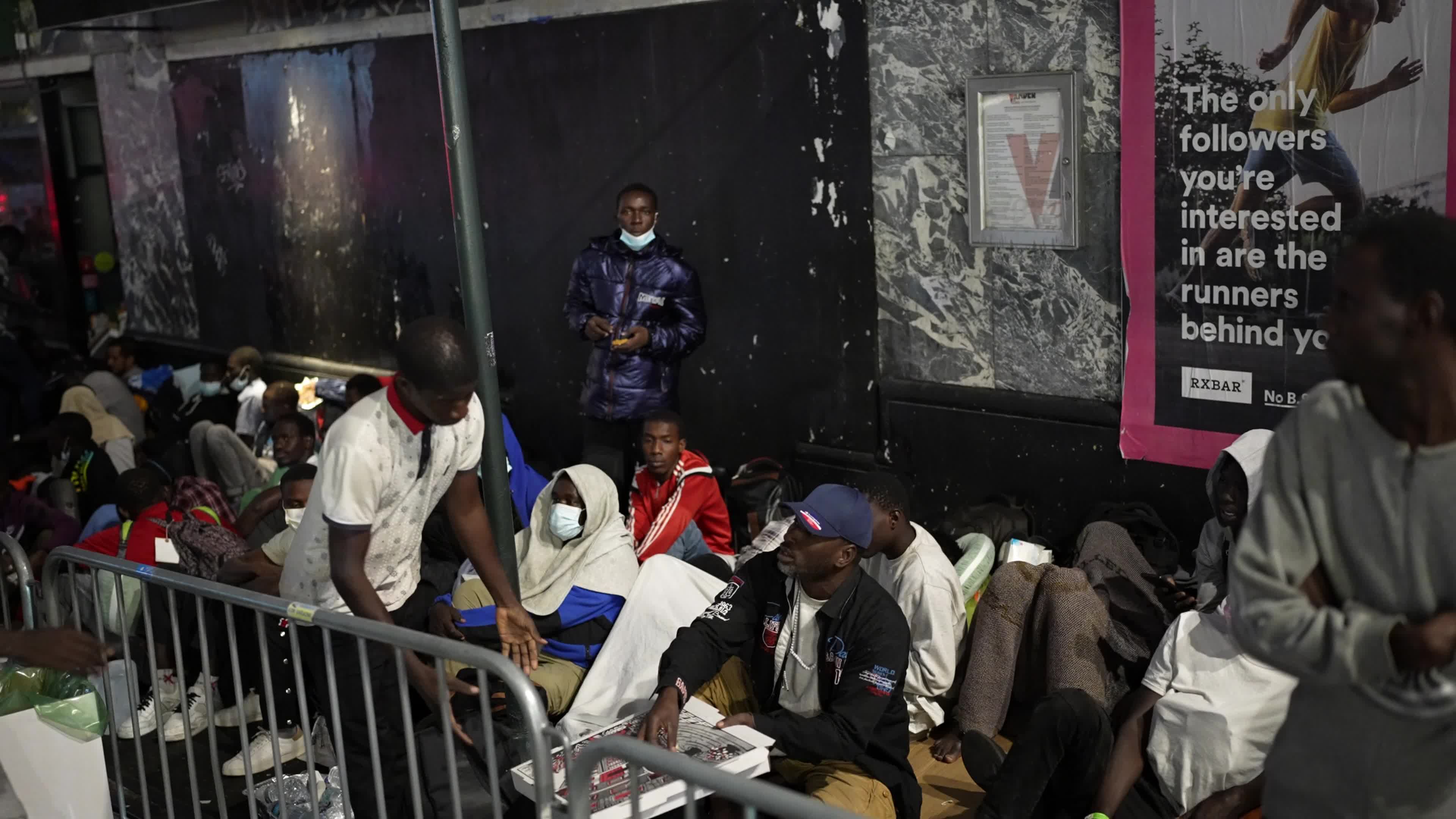 Asylum Seekers Line Up and Wait for Housing