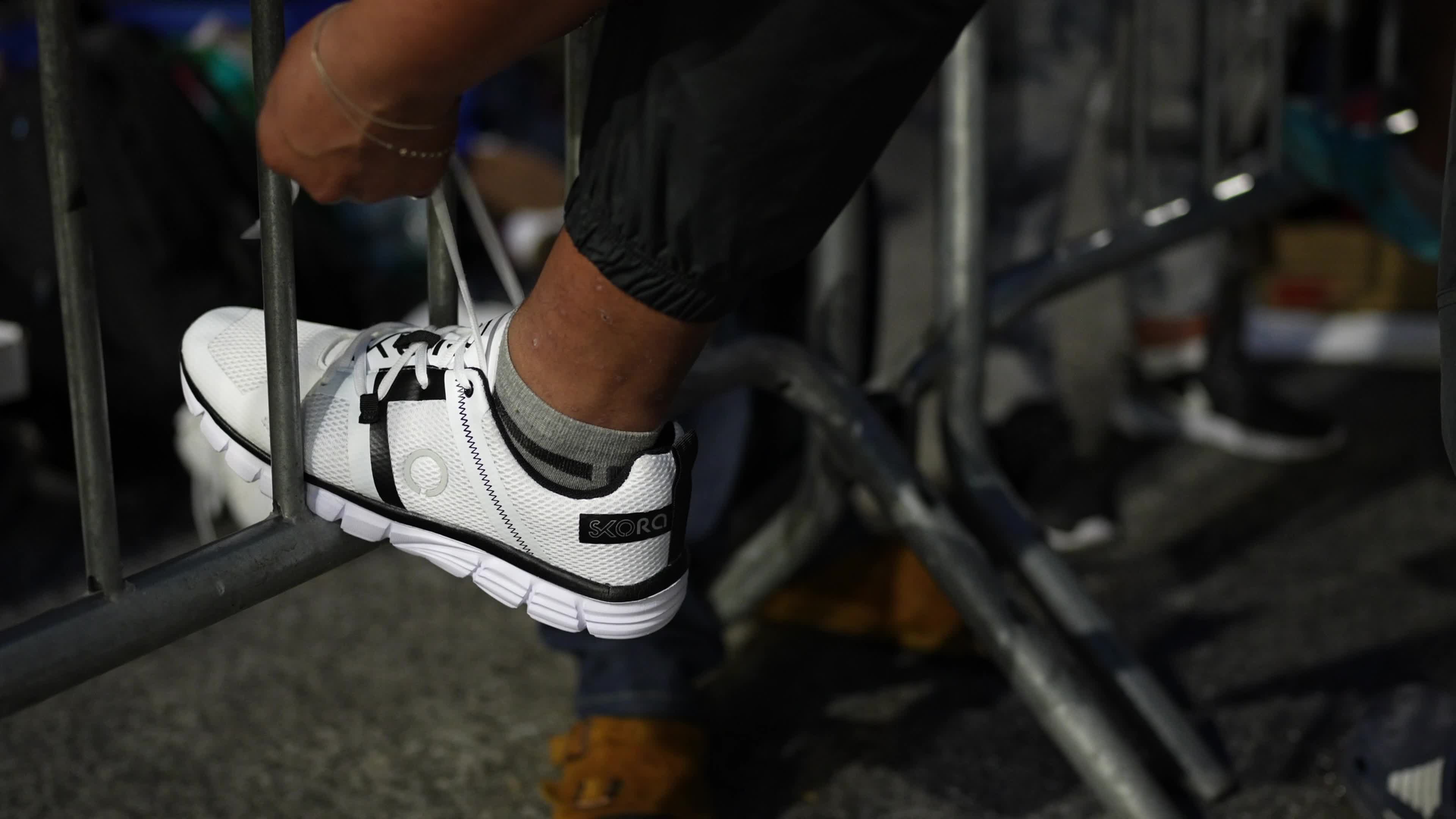 Asylum Seekers Line Up and Wait for Housing