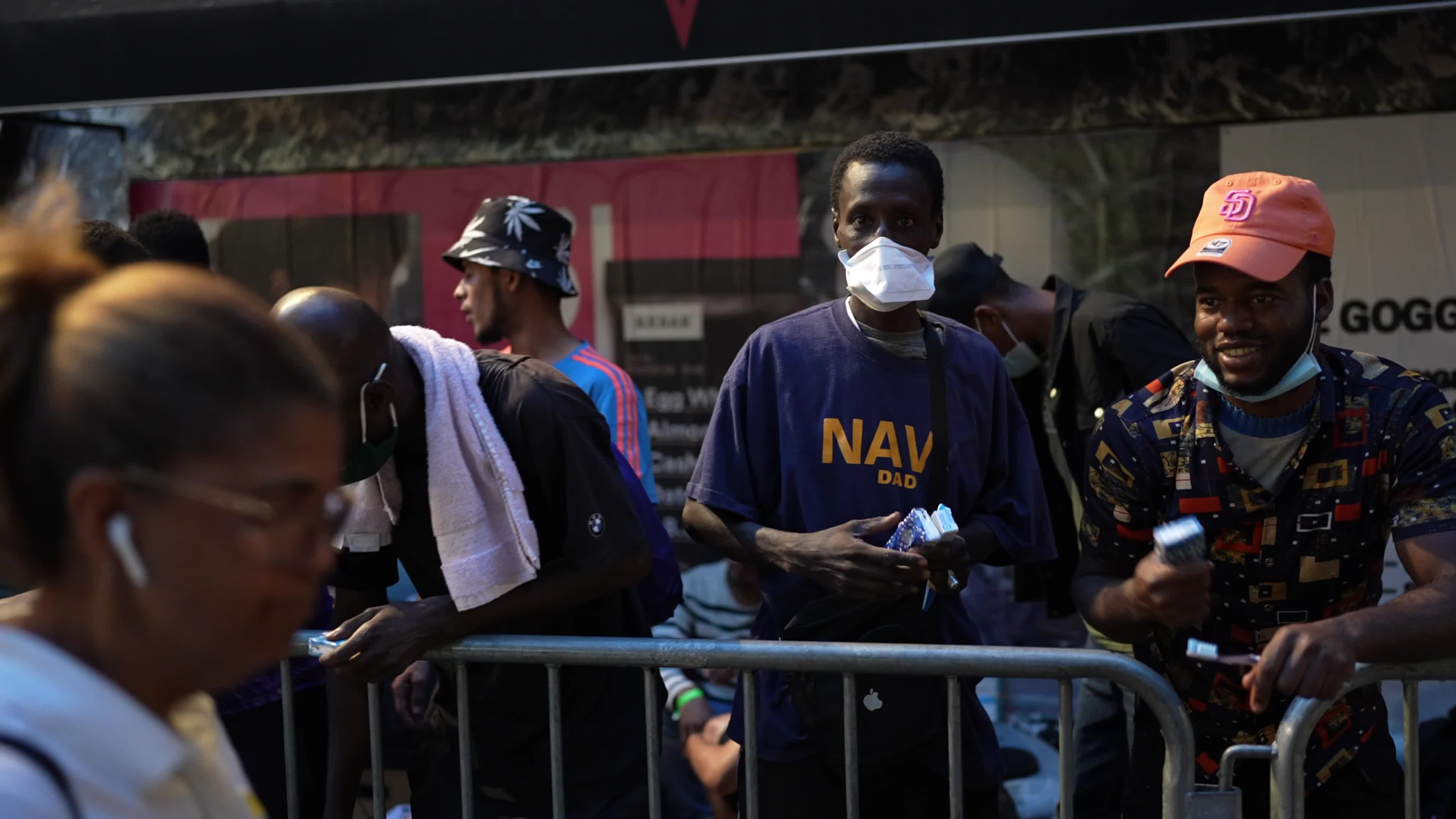Asylum Seekers Line Up and Wait for Housing