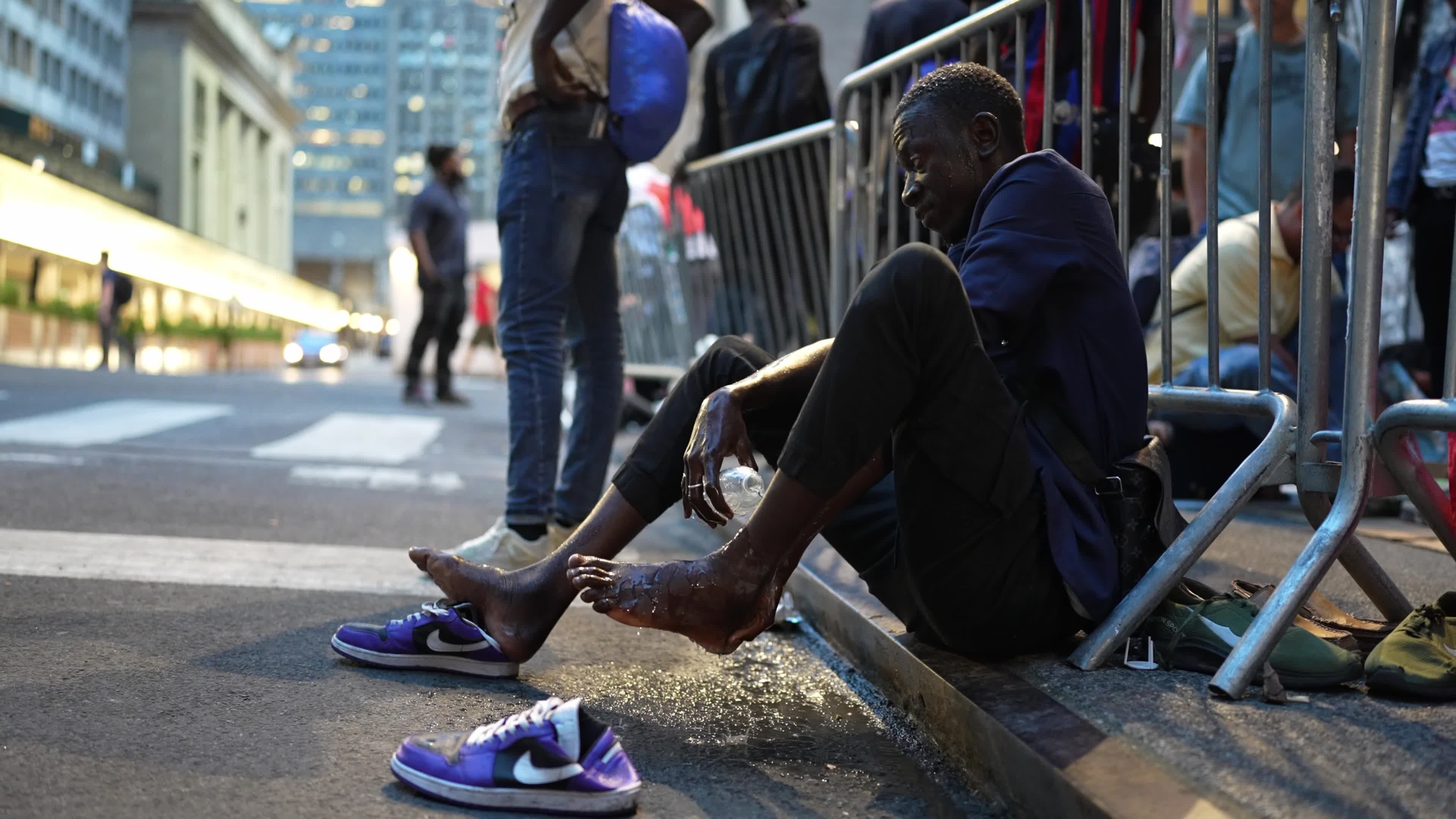 Asylum Seekers Line Up and Wait for Housing