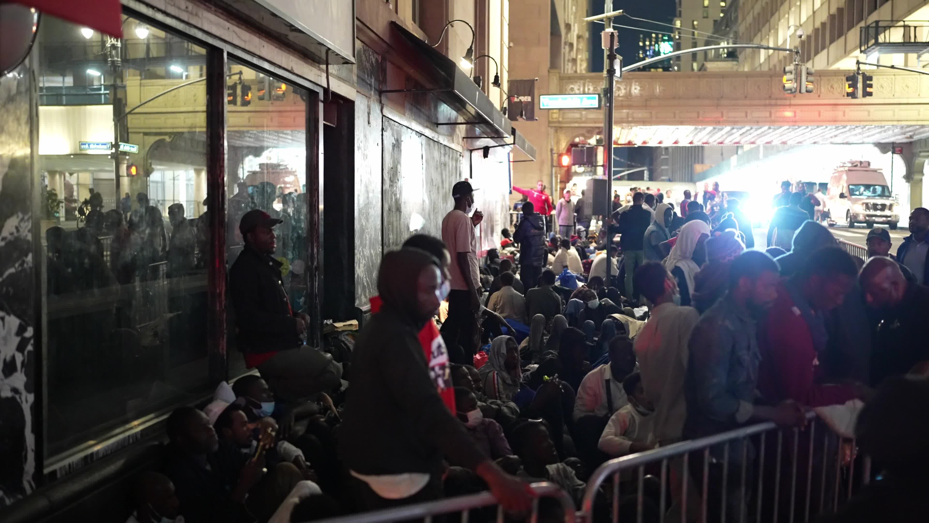 Asylum Seekers Line Up and Wait for Housing