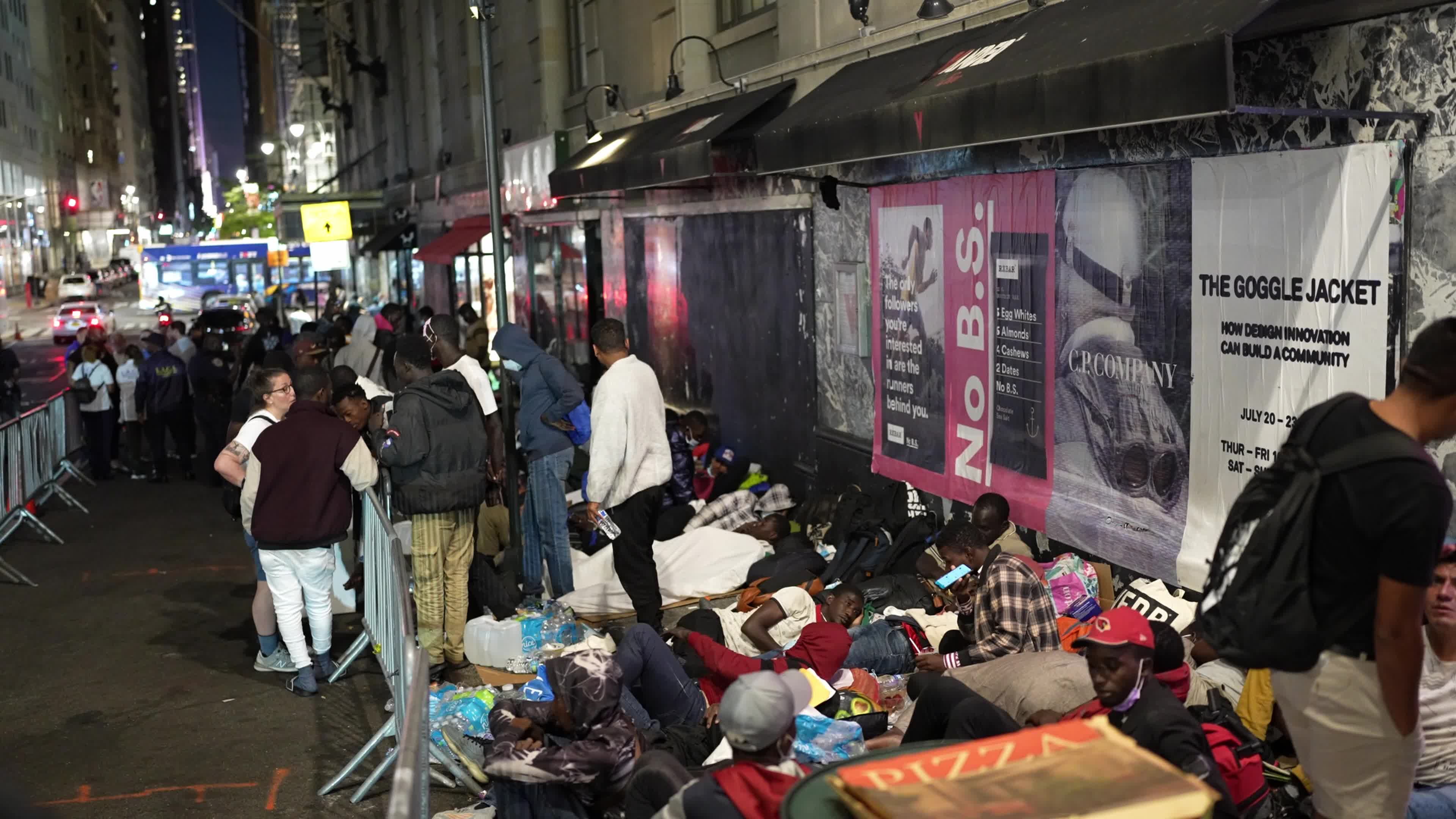 Asylum Seekers Line Up and Wait for Housing