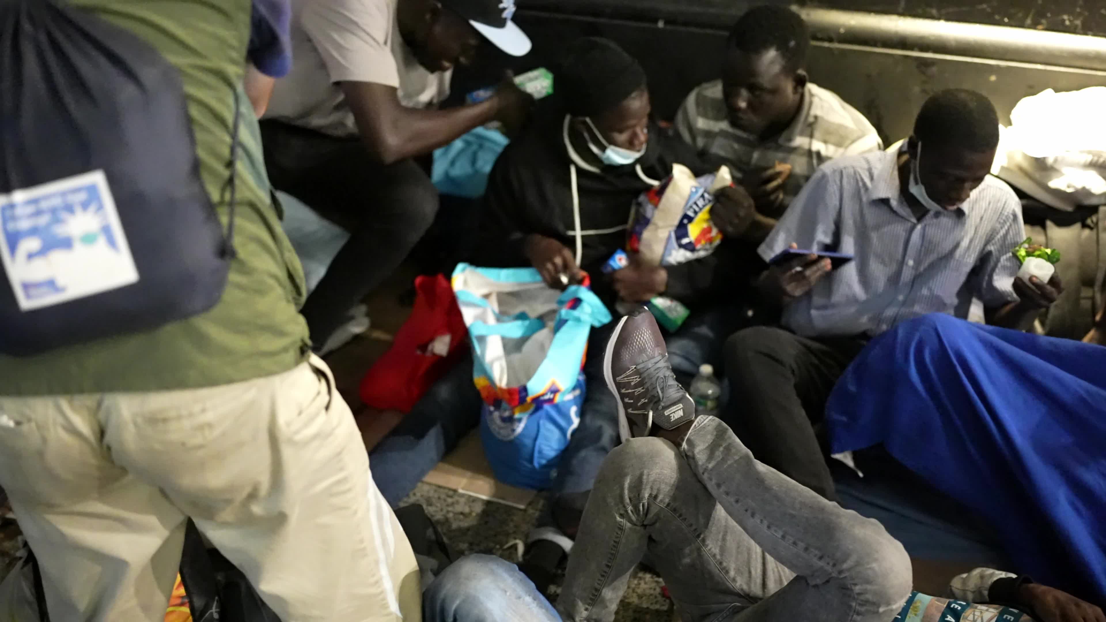 Asylum Seekers Line Up and Wait for Housing