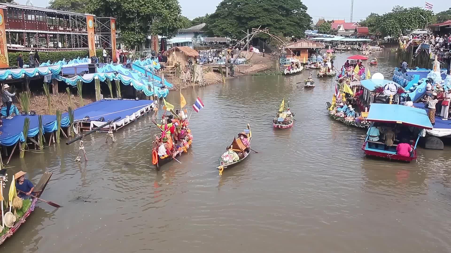 Boats carrying wax castles move along the Lat Chado canal